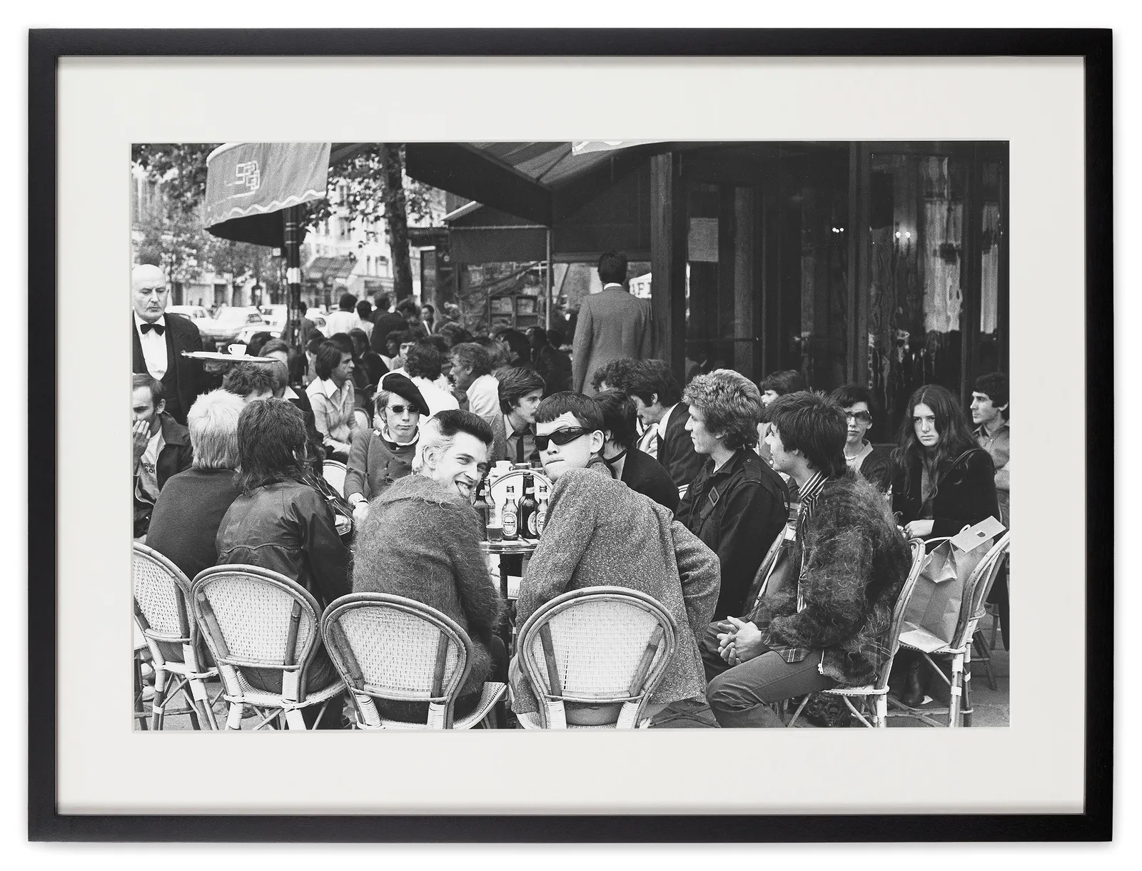 <div class="artist">Caroline Coon</div><div class="title_and_year"><span class="title">The Sex Pistols - Paul Cook,  Johnny ‘Rotten’ Lydon,  Steve Jones and Glen Matlock – and photographer Ray Stevenson meet up with the band’s fans - Siouxsie Sioux, soon to be on stage with Steve Havoc as Siouxsie and the Banshees and Billy, soon to be Bill</span><span class="year">, 1976</span></div>