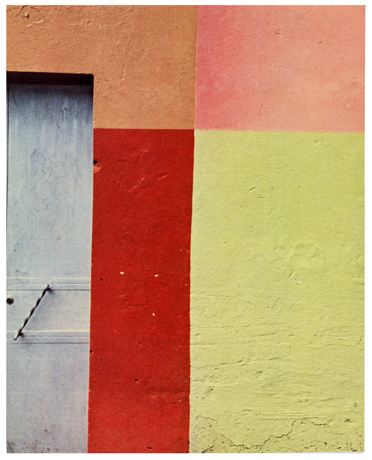 A color photo shows painted color blocks painted on a wall outside.