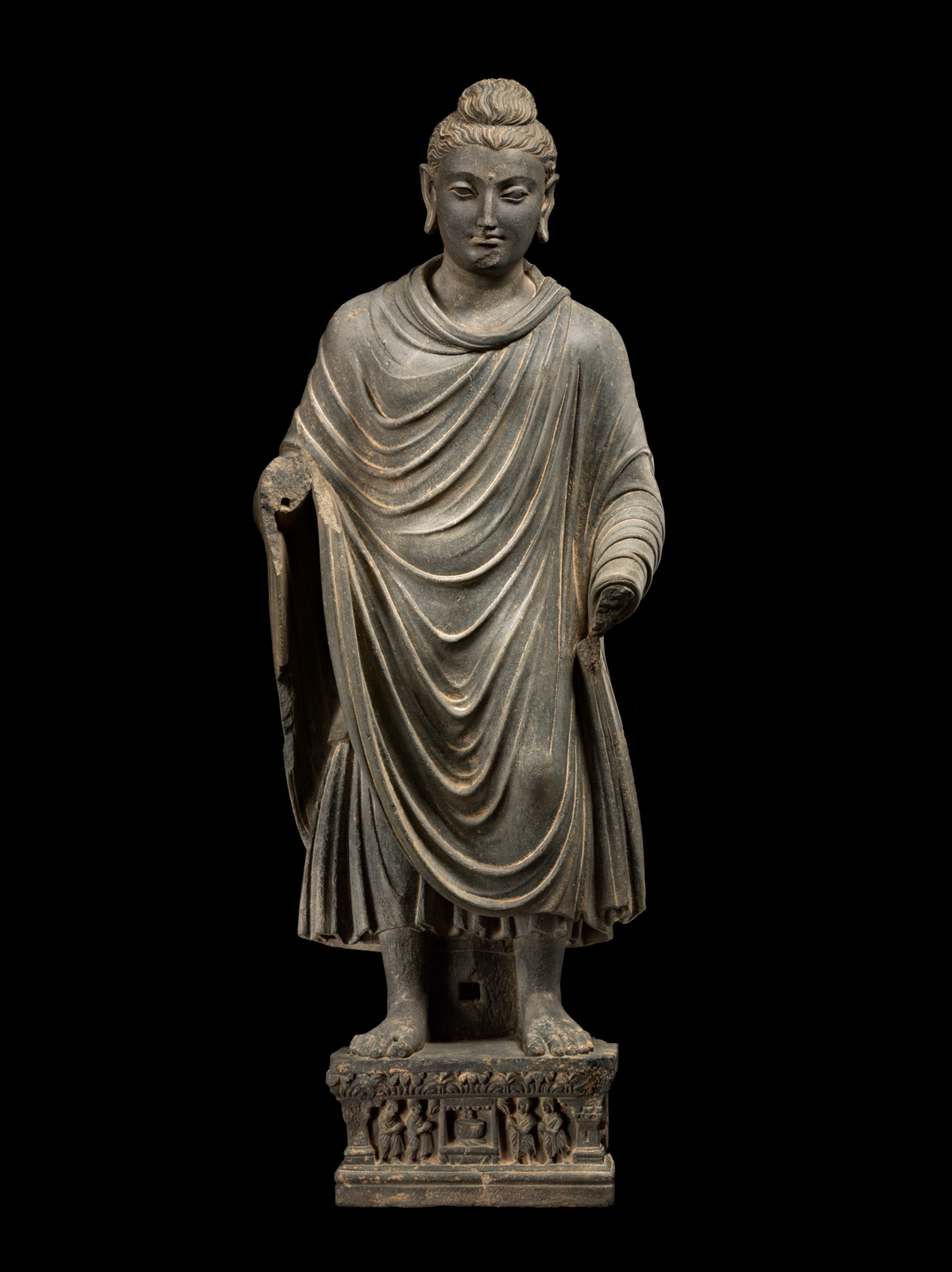 This standing Buddha exemplifies the refined naturalism and formal elegance characteristic of Gandharan Buddhist art.