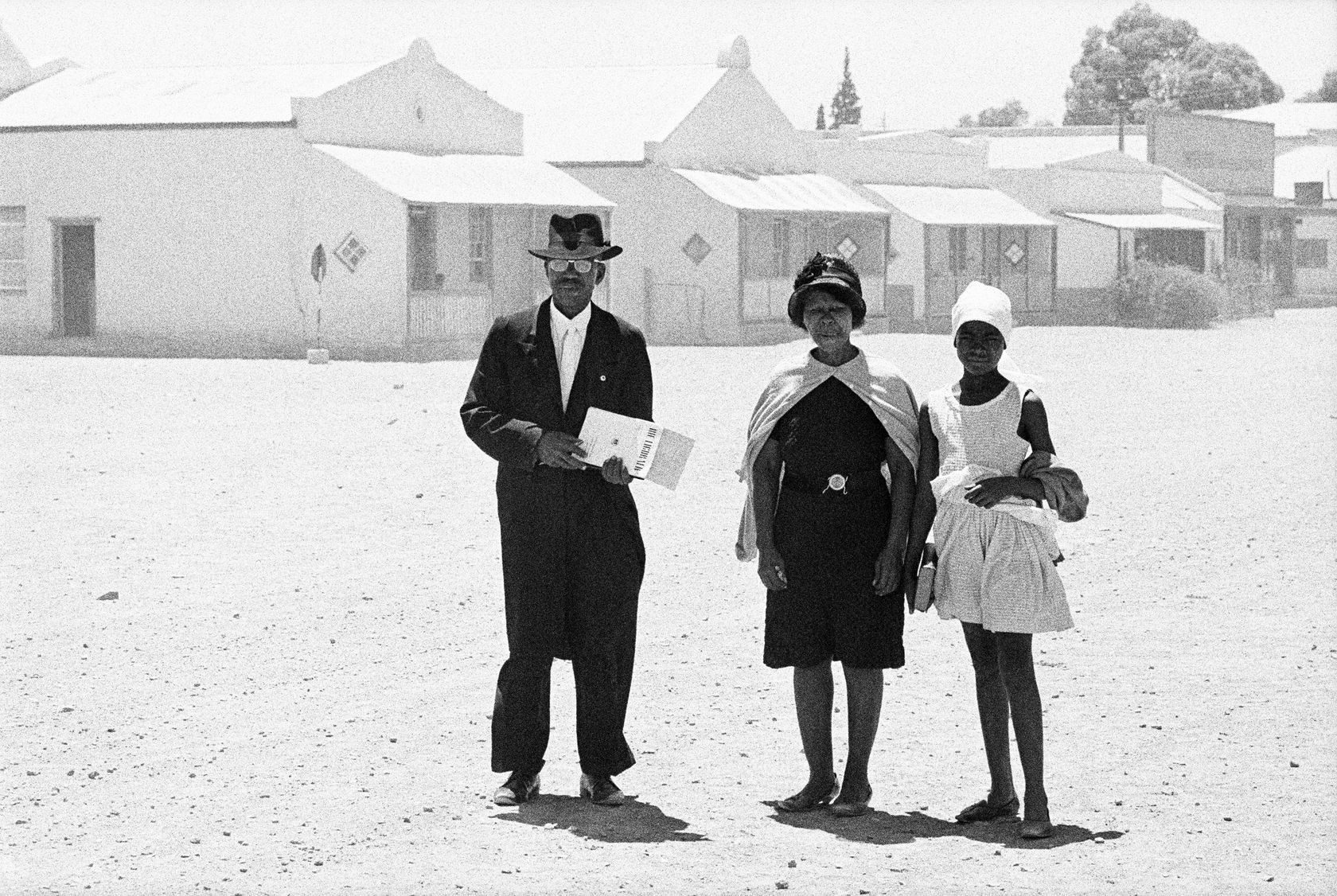 David Goldblatt An elder of the Dutch Reformed Mission church walking home with his family after the Sunday service, Carnavon,...