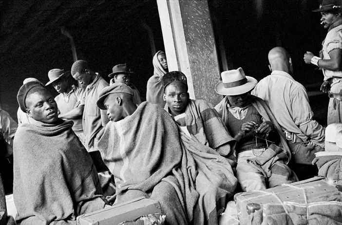 David Goldblatt Migrant mineworkers who had served their contracts on the gold mines and were waiting for a train to...