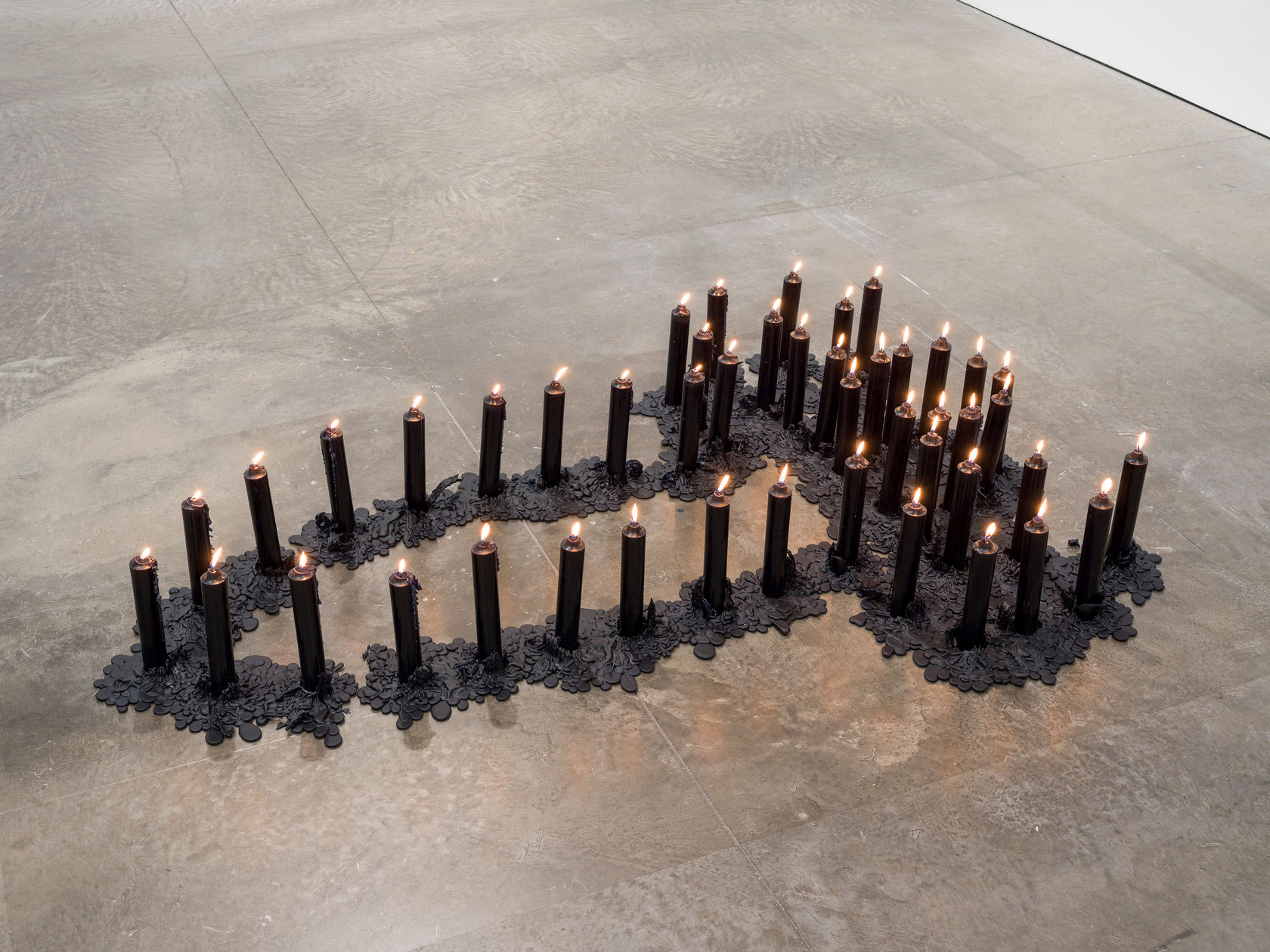 Ana Mendieta Ñañigo Burial, 1976 47 black ritual candles 60 x 45 in. (152.4 x 114.3 cm) Edition of 3...