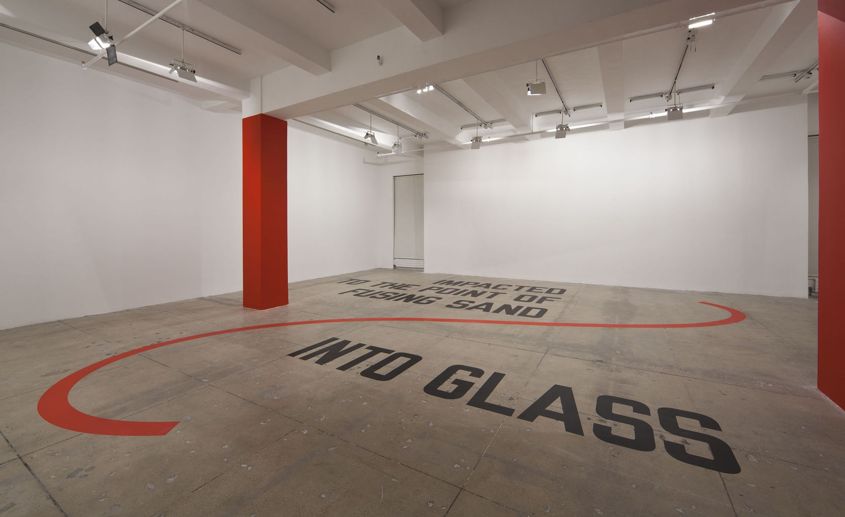 In a large white space with a beige floor and two red columns, large black texts, with a red swoosh design running through it, reads: IMPACTED TO THE POINT OF FUSING SAND INTO GLASS.