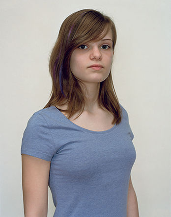 A Rineke Dijkstra portrait of a girl in a blue shirt.