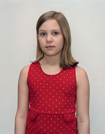 A Rineke Dijkstra portrait of a girl in a red polka dot dress.