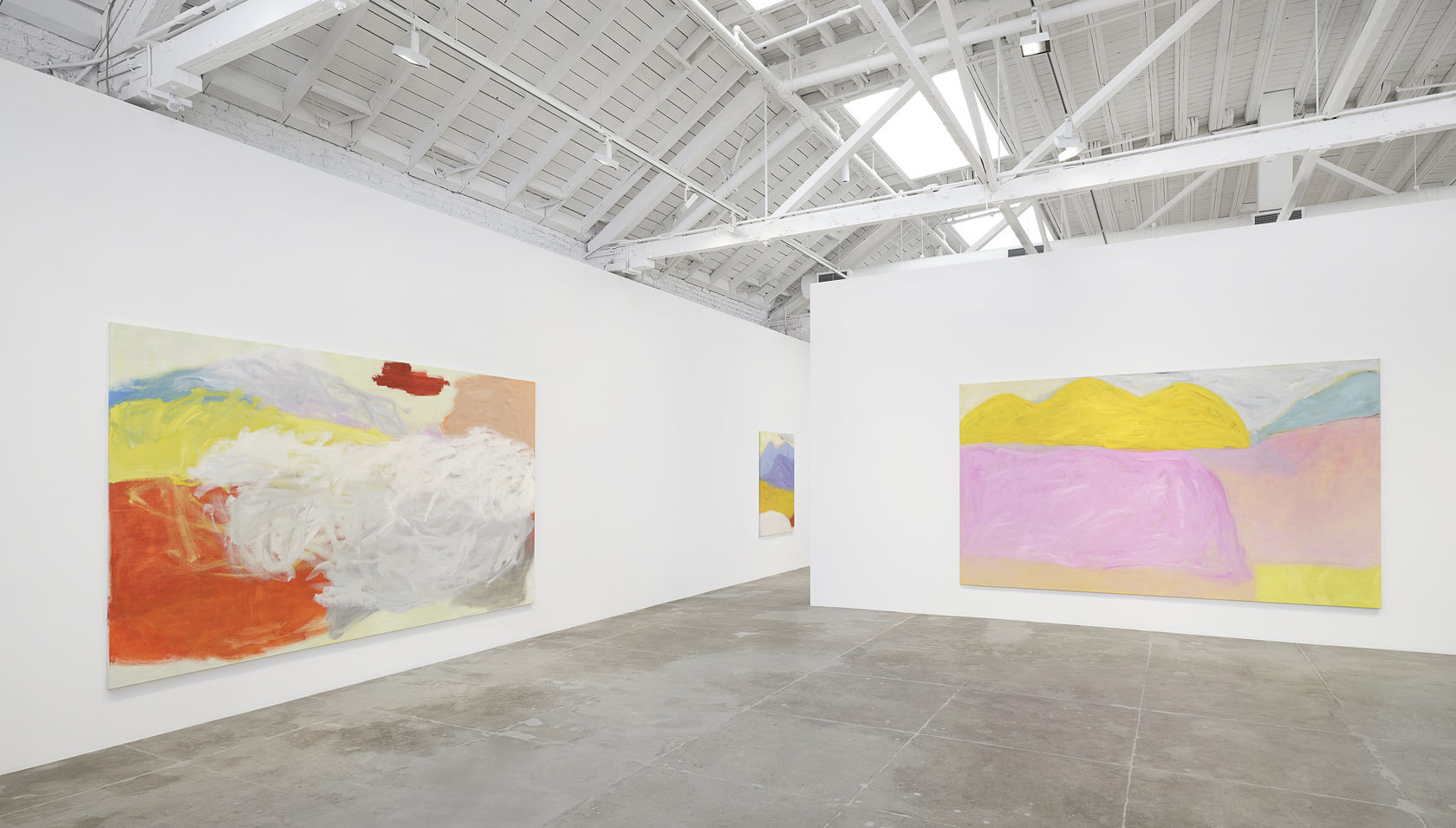 Three large landscape paintings by Jongsuk Yoon hanging in a white gallery space
