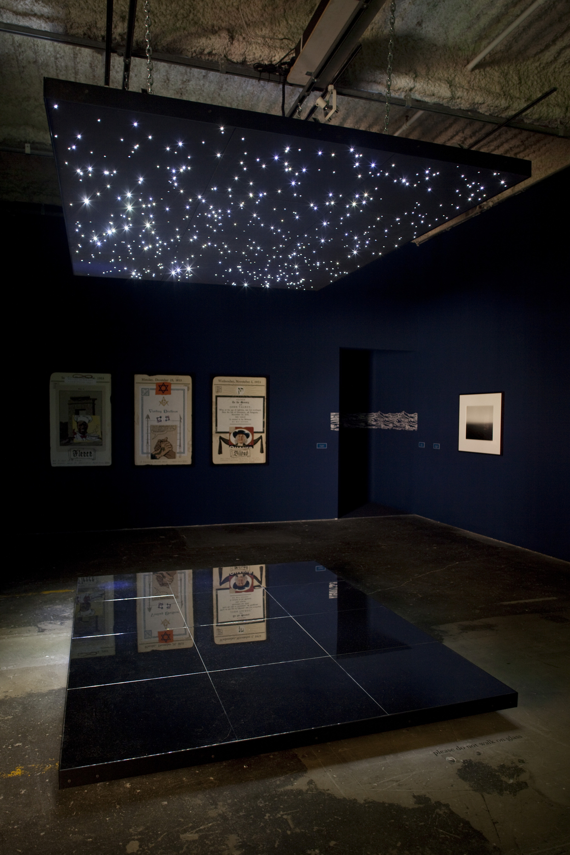 Night Sky: Mars from Venus: 12, 2007 (on ceiling and floor) Grid of 12 squares, preshrunk neoprene, aluminium and black...