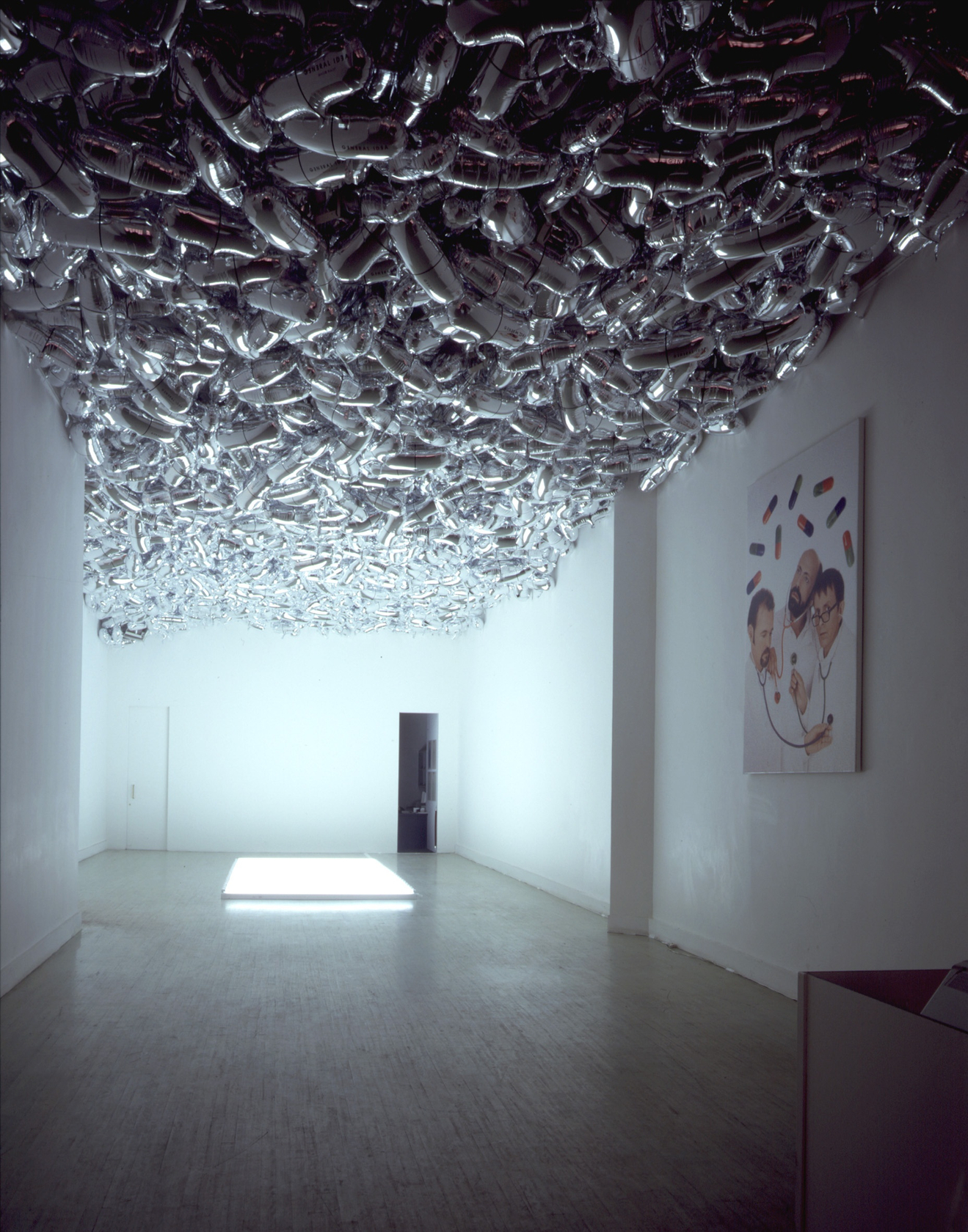 Magi© Bullet, 1992 (ceiling) Silver helium-filled Mylar balloon, multipart Shaped like pharmaceutical capsules, helium-inflated silver balloons cover the ceiling of...