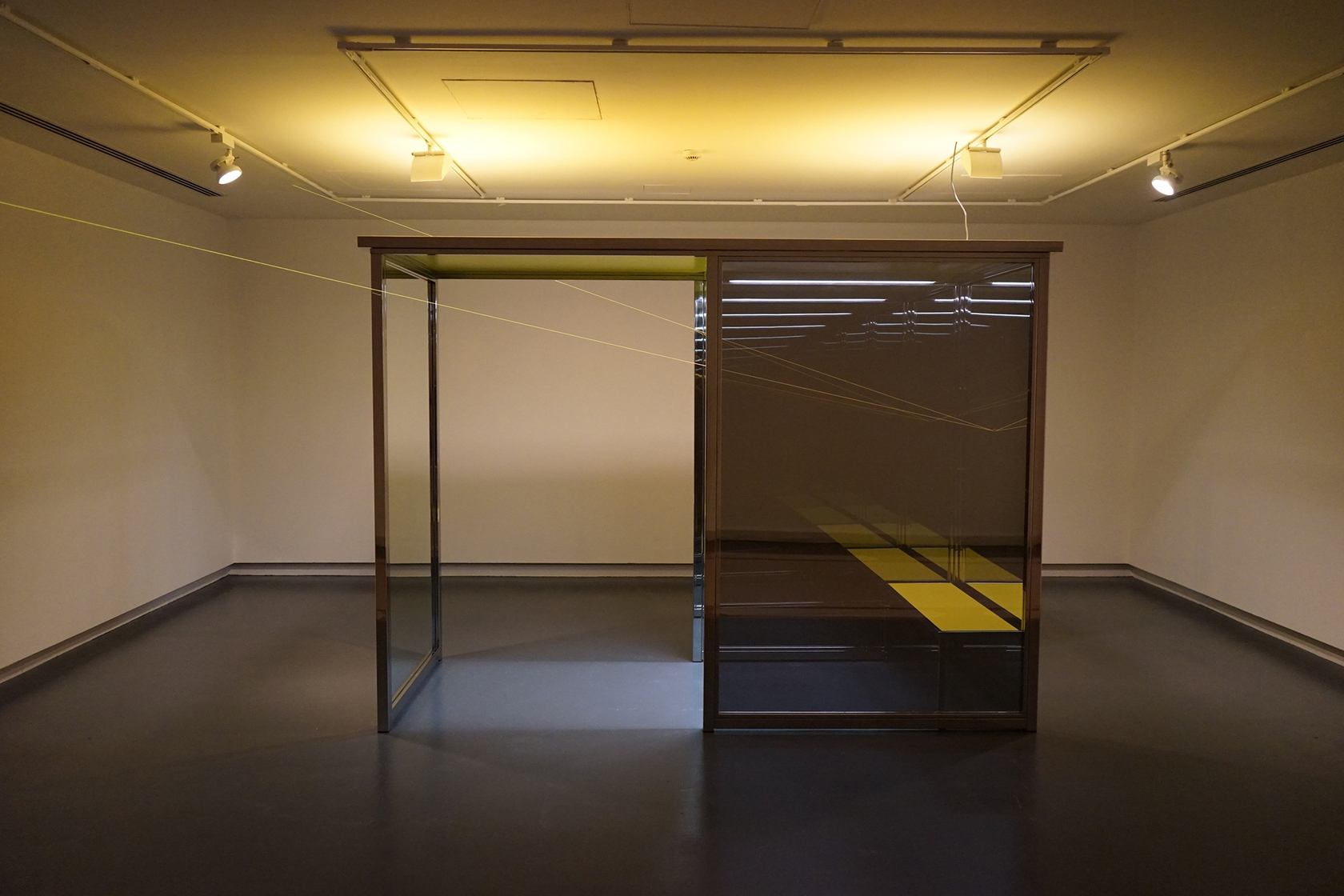 Vanishing Waiting Room, 2008 6 polished stainless steel tubes, 2 one-way mirrors, 2 two-way mirrors, yellow MDF roof, yellow bench,...
