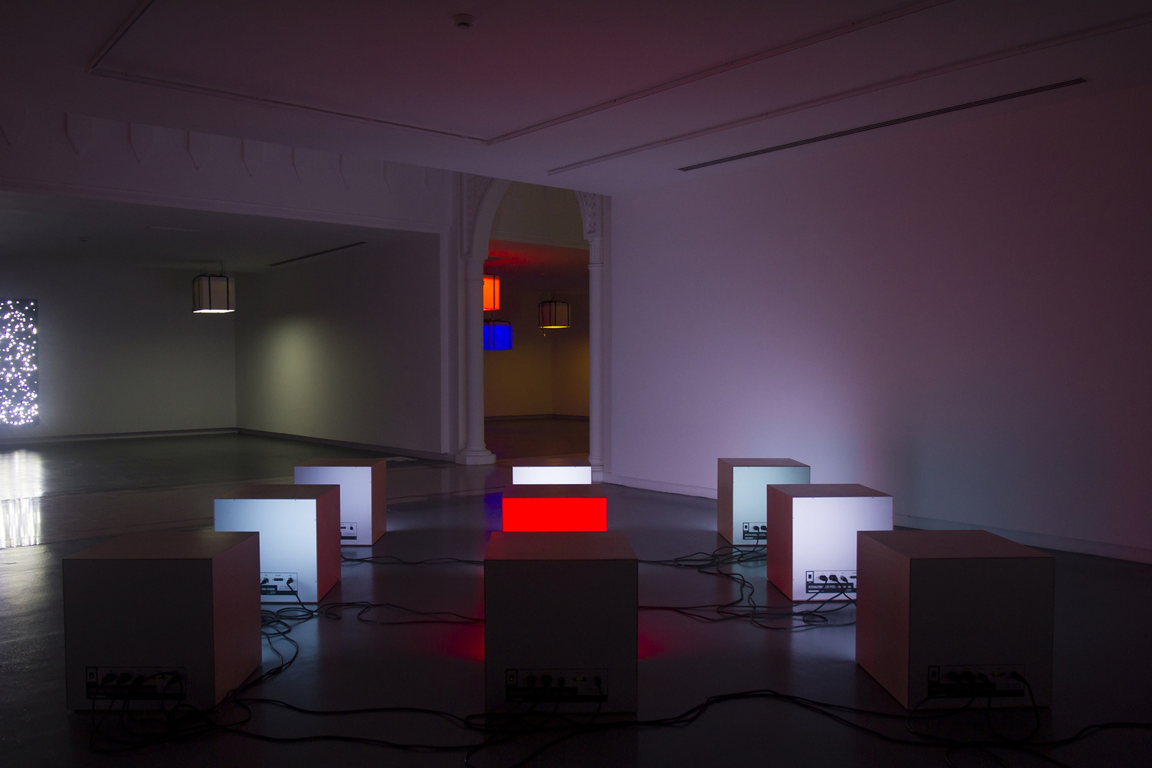 Floor Scatter Nine, 2015 (foreground) 9 wooden boxes, international LED DMX modules, black box Night Sky: E.T. From Pluto.9, 2008/2012...