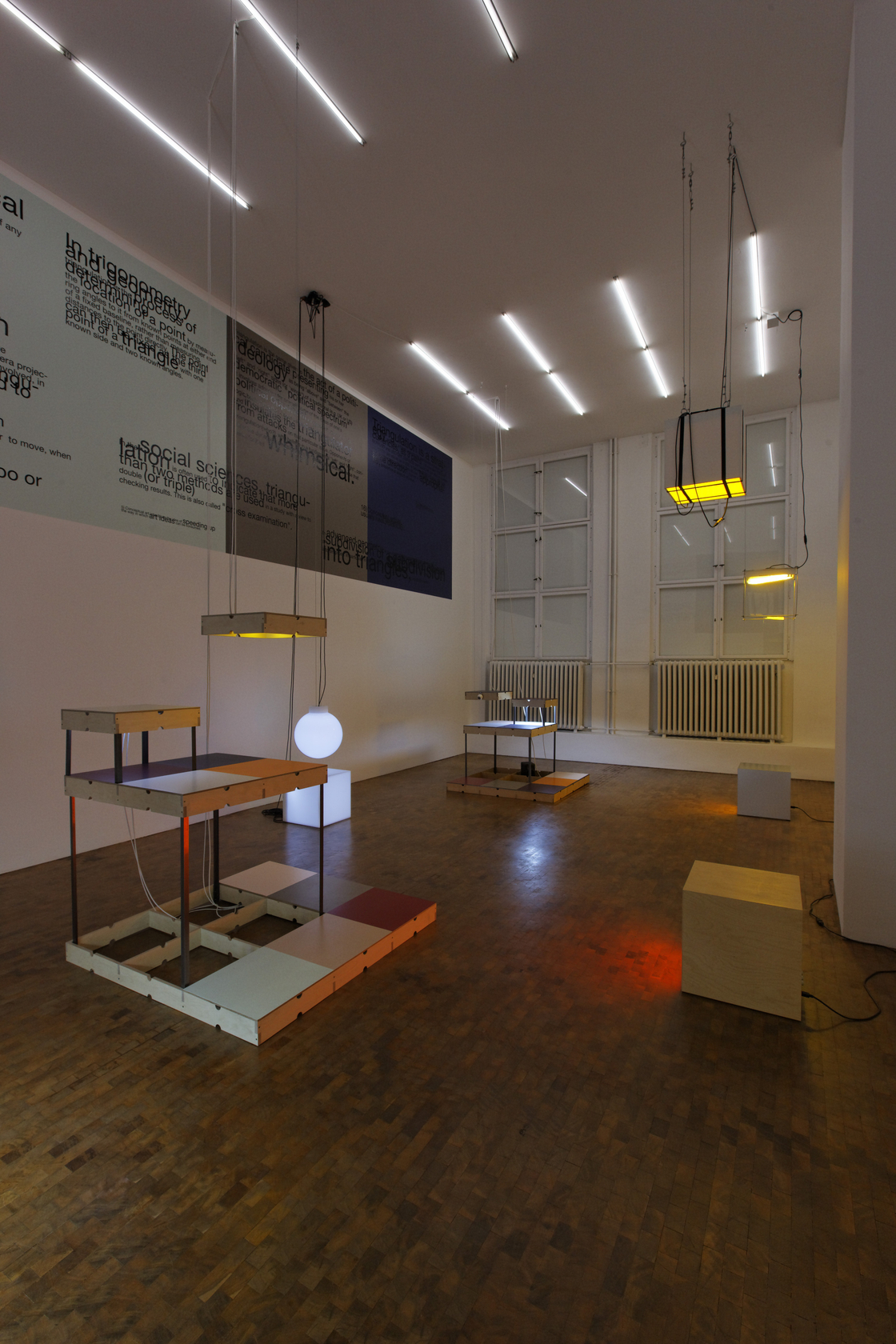 Triangulation Remix (Wall Painting), 2010 Paint, vinyl letters Pong, 2010 (front, left) Wood, steel, two mono sound tracks each with...