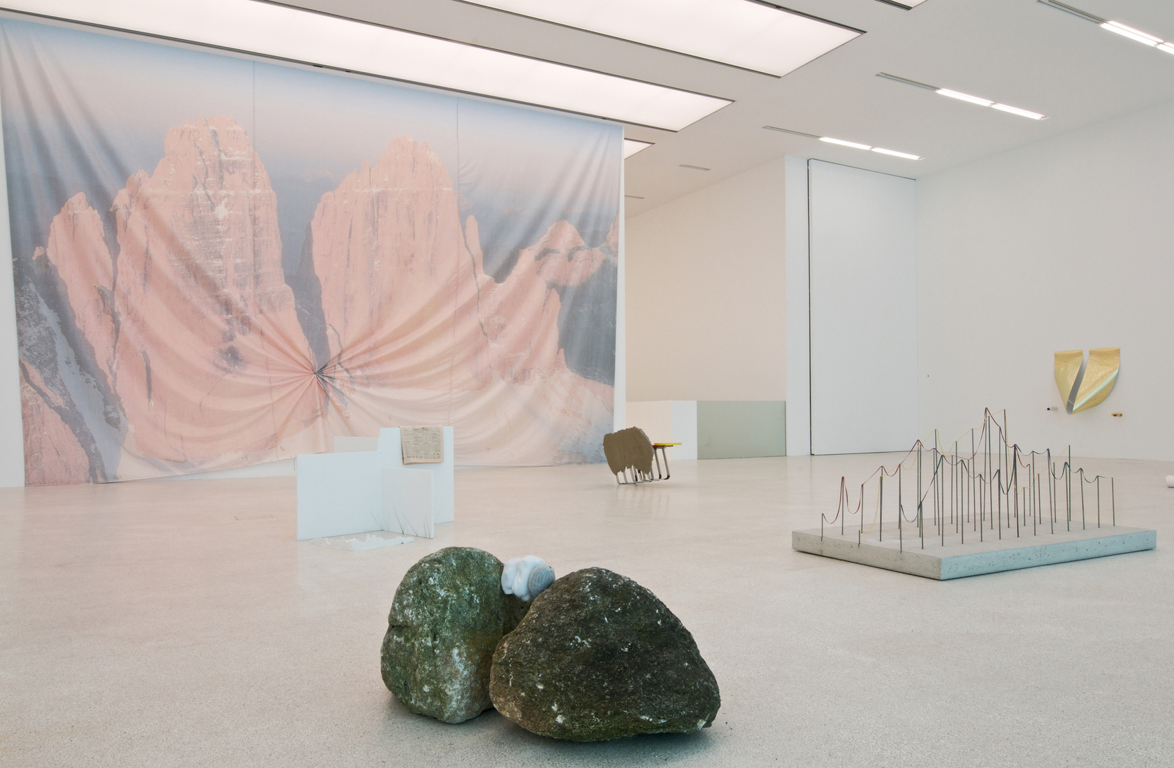 Three Landscapes, 2010 Polyester, glass, paper 2 banners on two separate walls A large white wall blocks the entrance to...