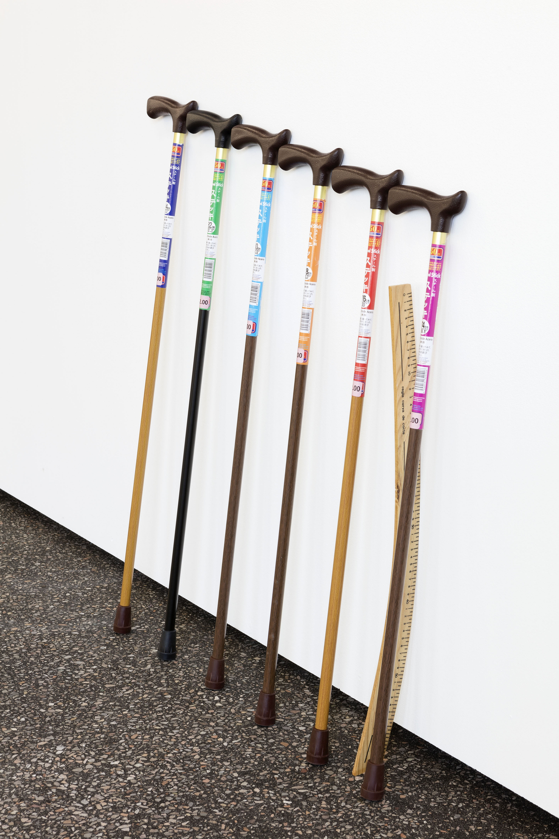 Untitled Chart (Wall 2), 2016 Walking sticks, ruler Six walking sticks of different sizes, from the Japanese brand Daiso, are...