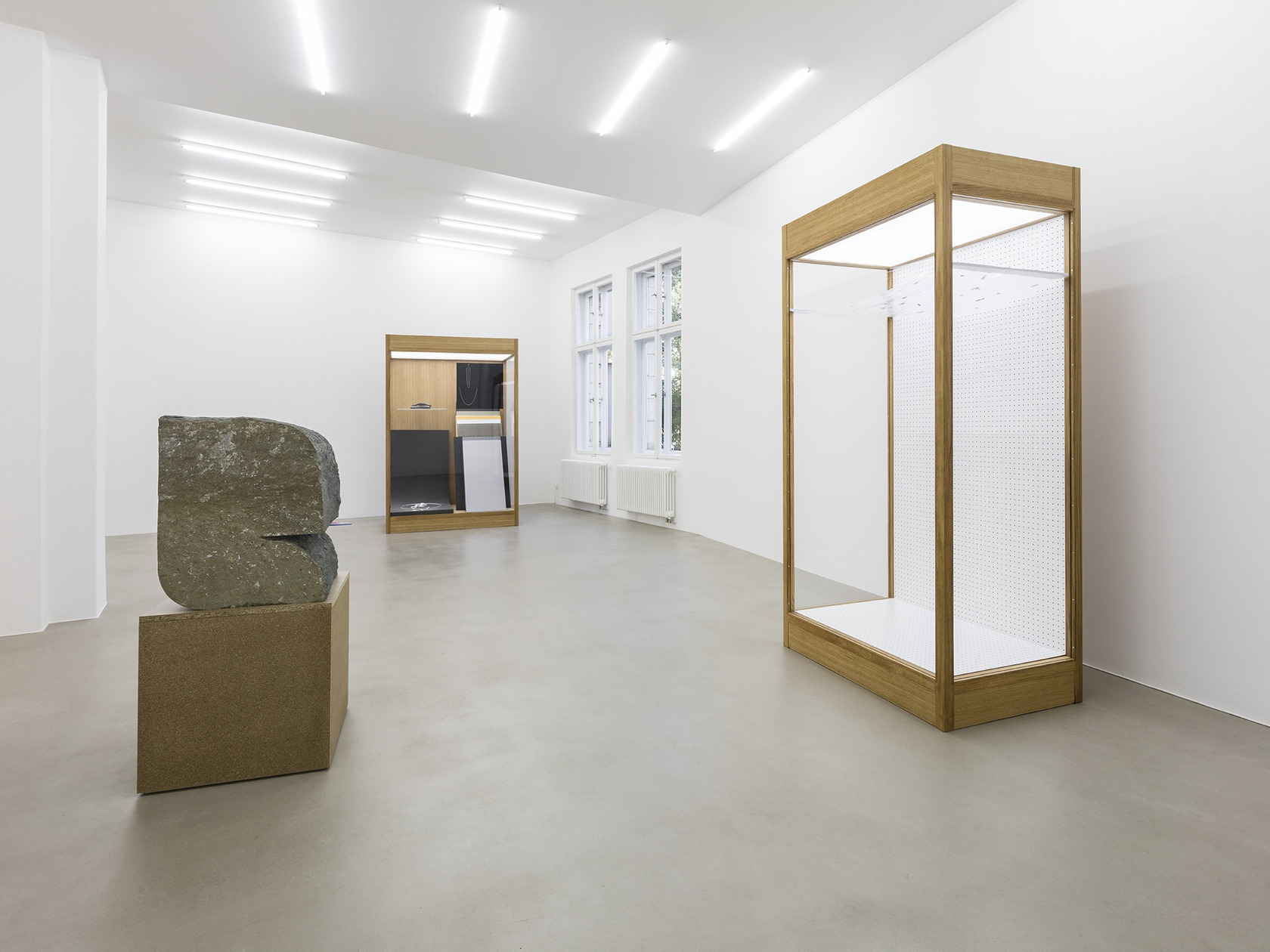 I collate, I convey, I comply (02), 2015 (left) Green Anröchter stone, chipboard plinth, assorted objects The sculpture’s combination of...