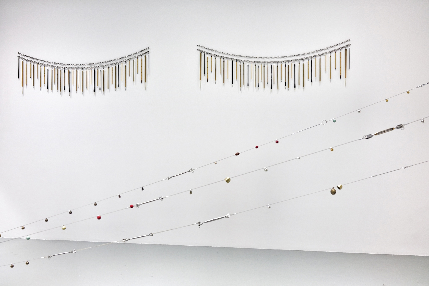 Buddha's Eyes, 2016 (front) Chinese brushes, steel chain 2 pieces: 15 x 158 cm each. Overall: 15 x 371 cm...
