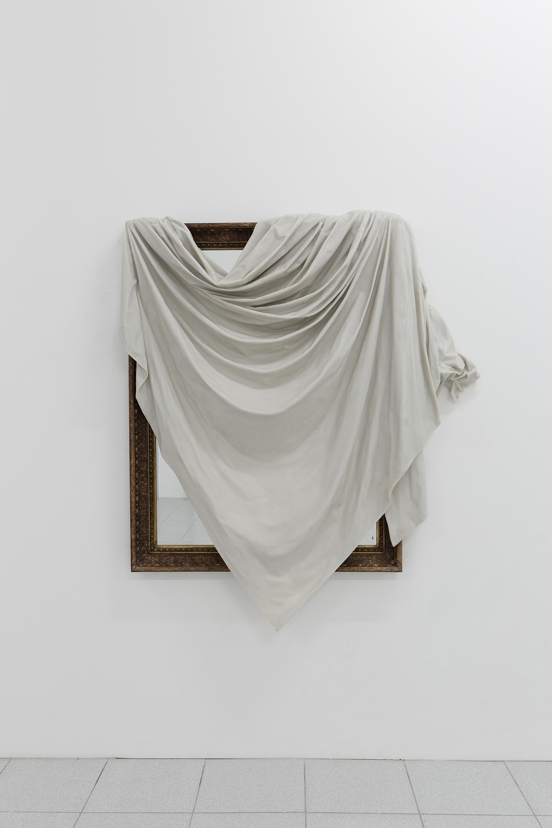 I be...(ii), 2015 An existing large framed mirror over which a dust sheet reproduced in marble resin has been draped...