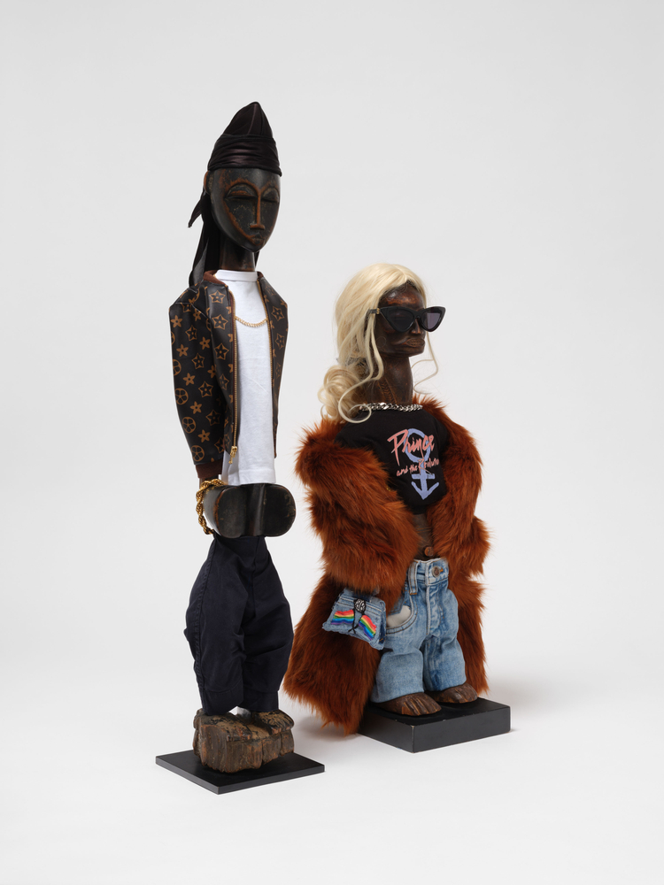 Ralph Lemon  Consecration of Ancestor Figures #13 and #14, 2024  carved wood and textile  #13: 28 x 9 x 5 in. (71.1 x 22.9 x 12.7 cm)  #14: 36 x 6 x 6 in. (91.4 x 15.2 x 15.2 cm)  costume production: Naoko Nagata