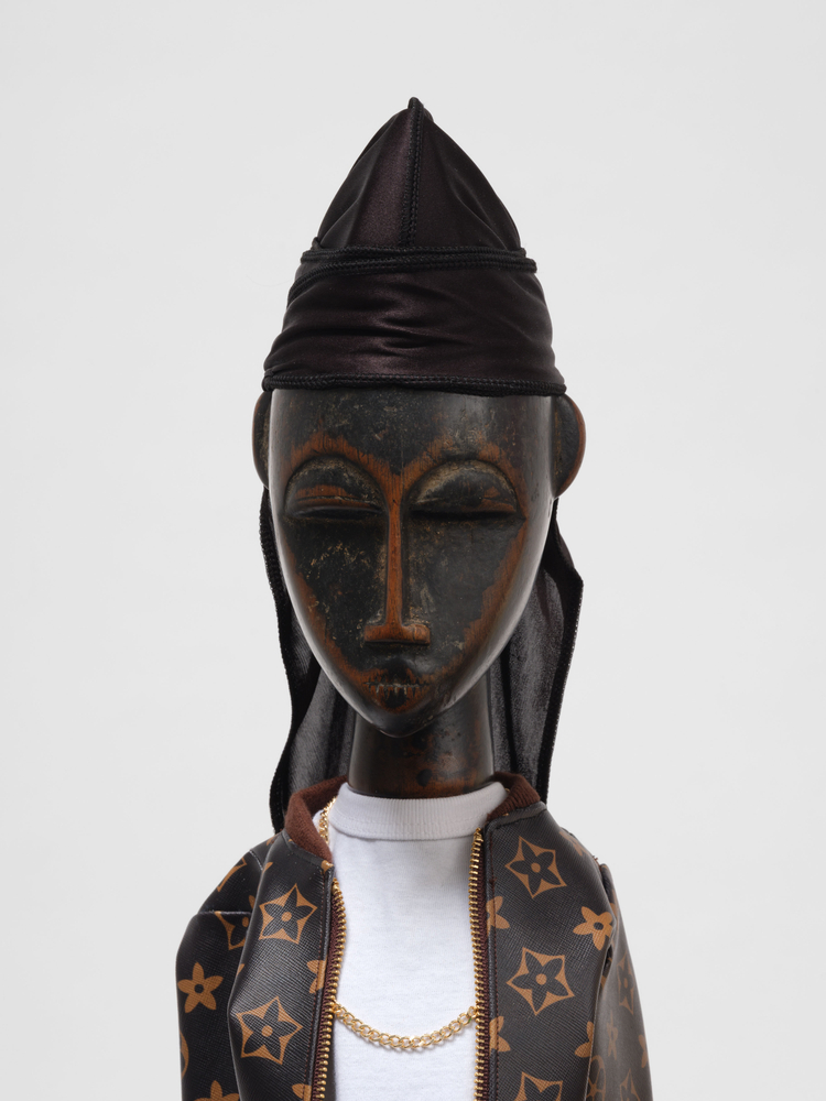 Ralph Lemon  Consecration of Ancestor Figures #13 and #14, 2024  carved wood and textile  #13: 28 x 9 x 5 in. (71.1 x 22.9 x 12.7 cm)  #14: 36 x 6 x 6 in. (91.4 x 15.2 x 15.2 cm)  costume production: Naoko Nagata