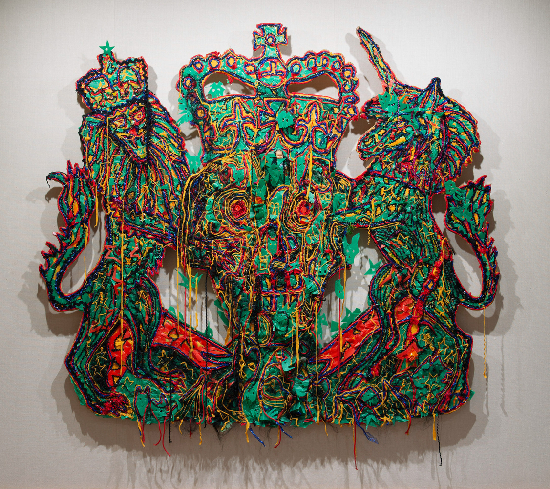 Hew Locke
Veni, Vidi, Vici (The Queen&amp;#39;s Coat of Arms), 2004
textile, plastic, oil stick, artificial hair, plywood
84 1/4 x 96 ins.
214 x 244 cm