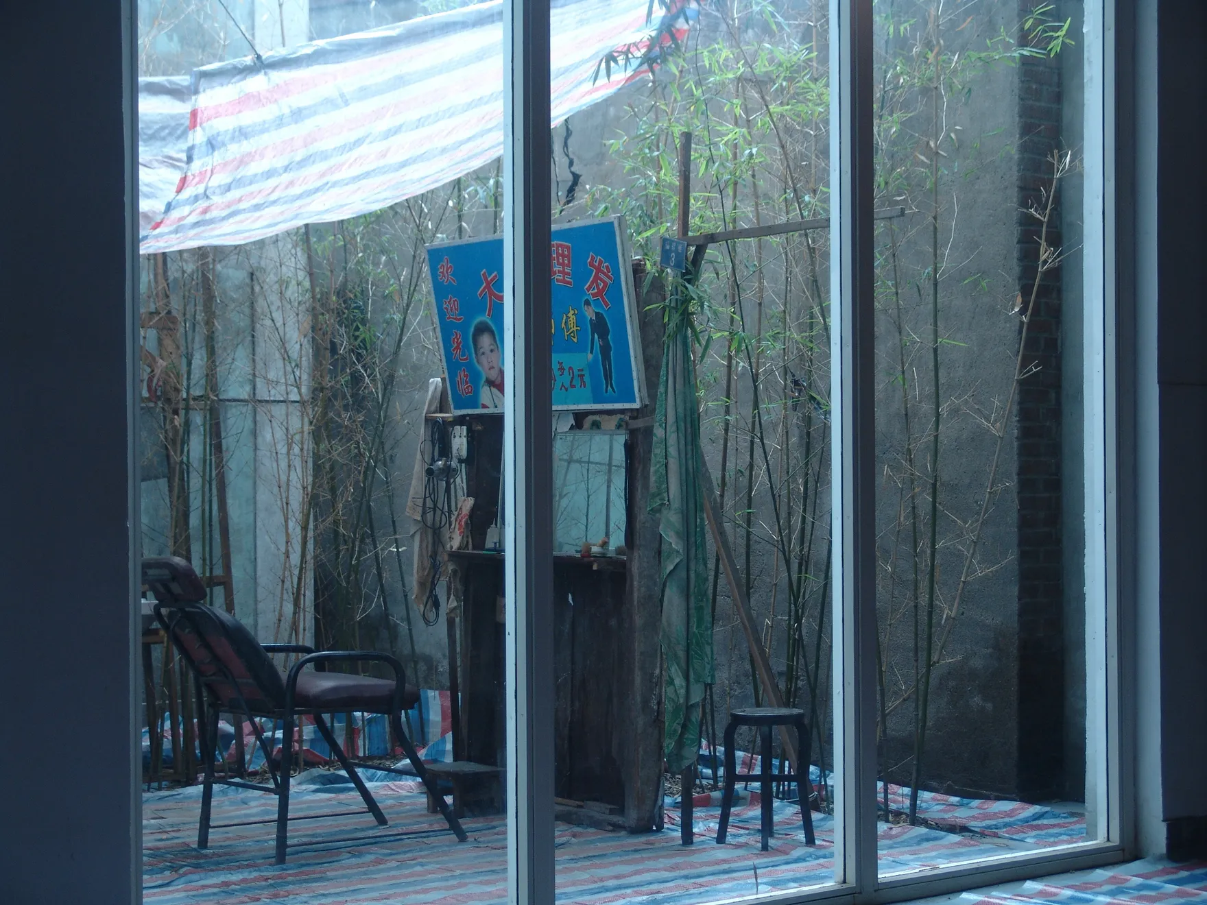 View of the open-air barber shop from inside of a house