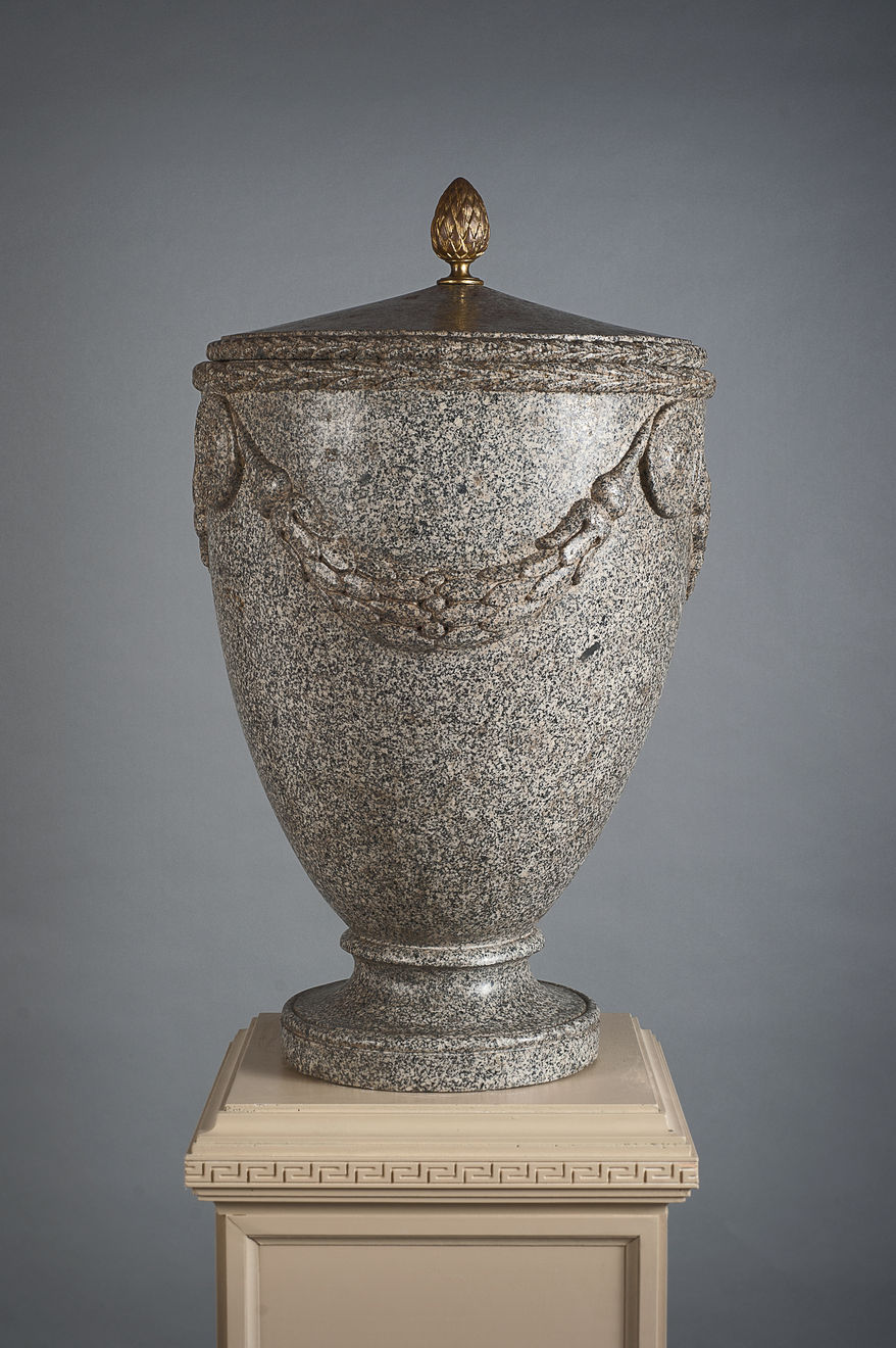 A granite vase with cover sormounted by a gilt handle and nicely sculpted with festoon motifs, Rome, 18th Century