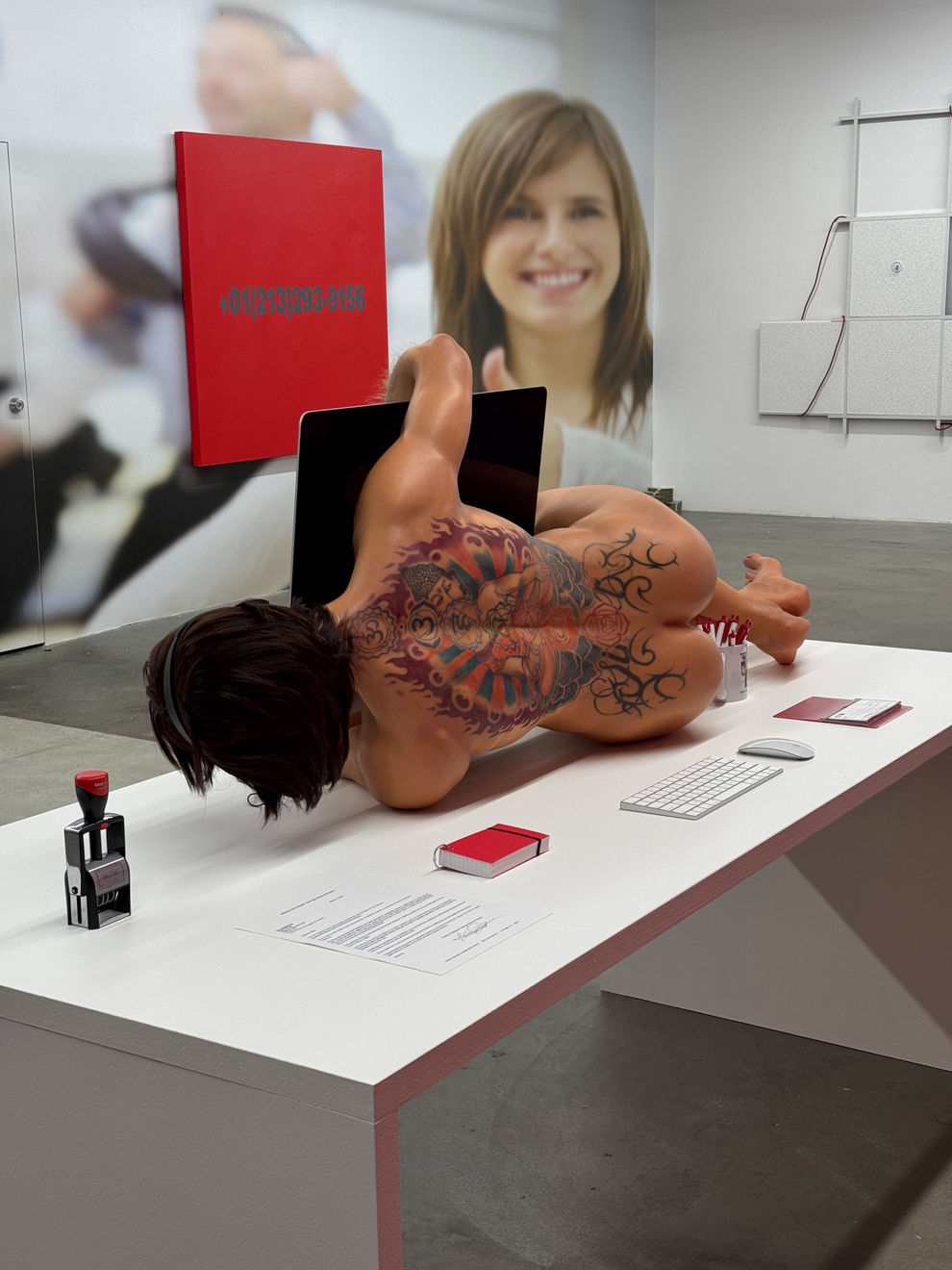 man on a desk hugging his computer