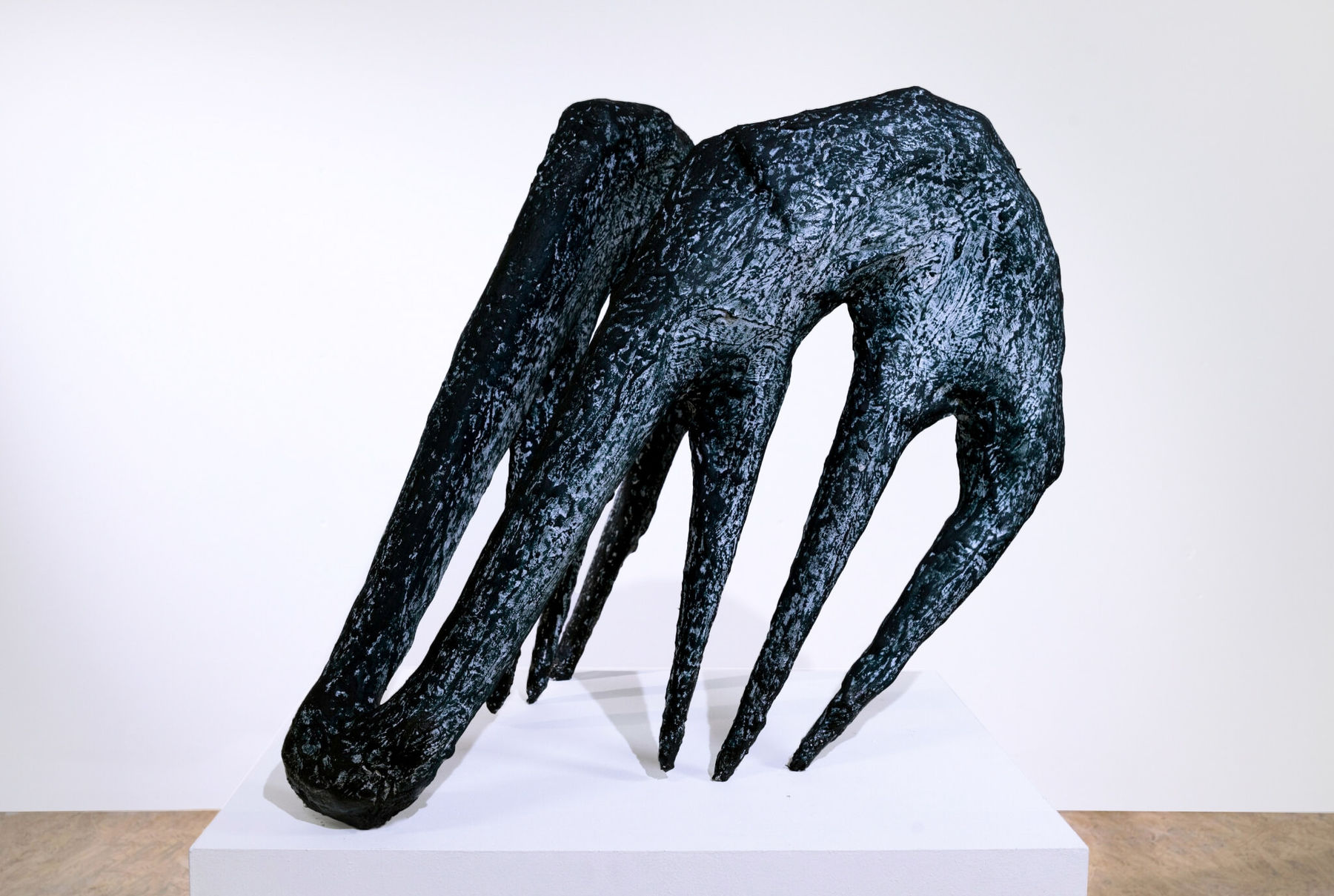 black sculpture resembling tongs