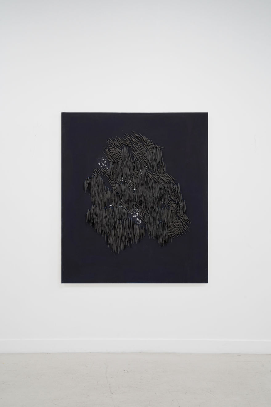 small ceramic needles sewn to a dark indigo canvas