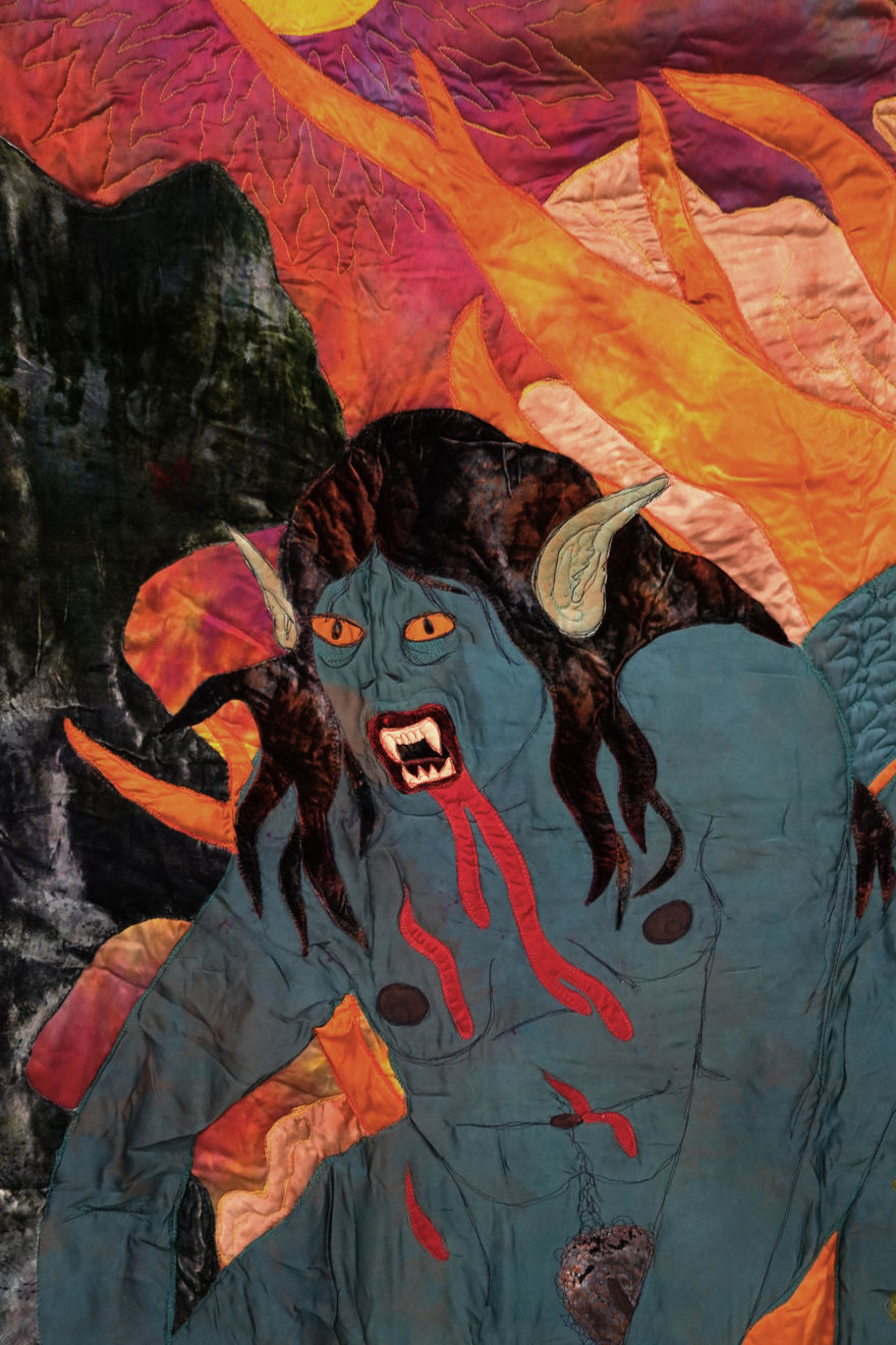 sewn tapestry hanging on wall