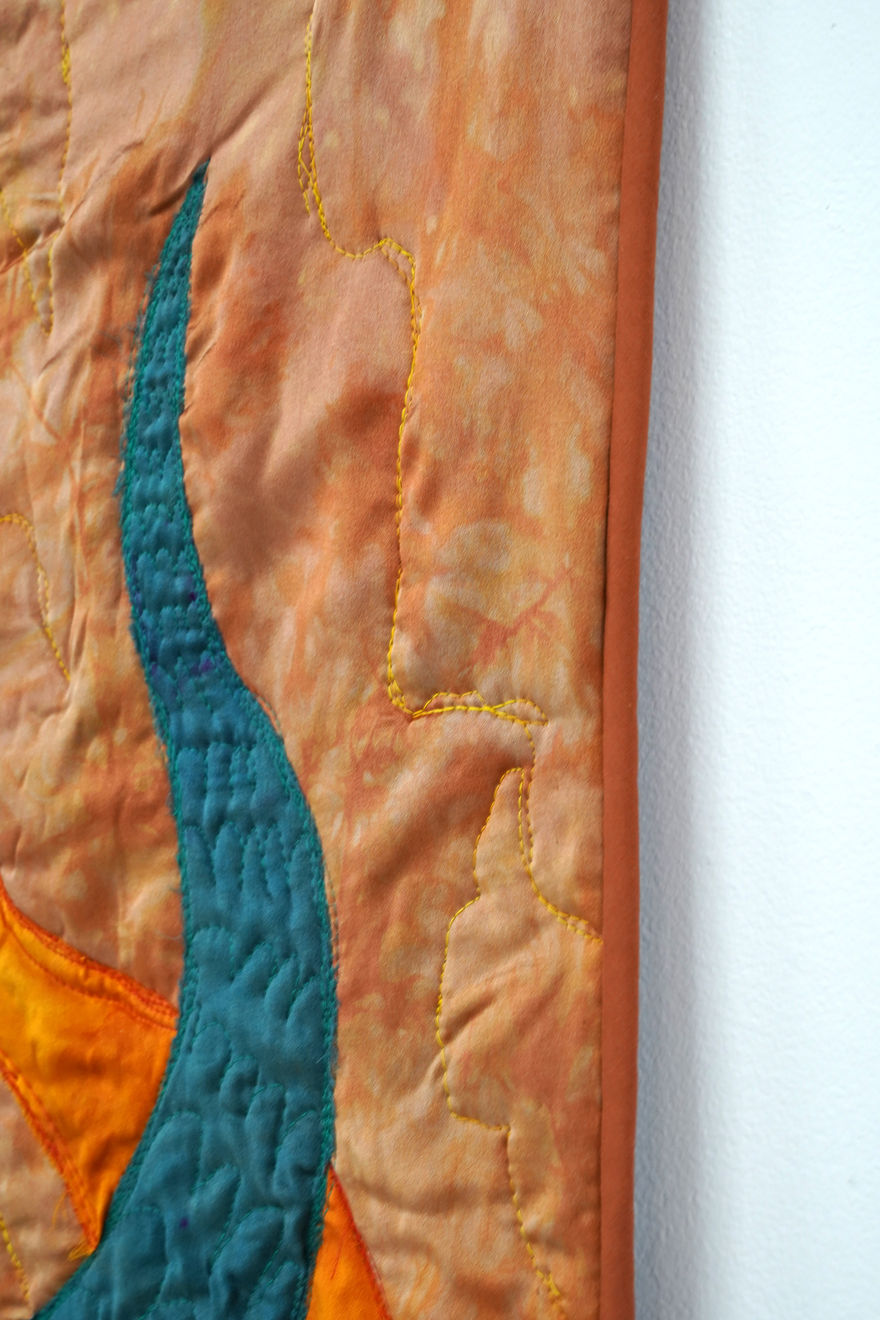 sewn tapestry hanging on wall