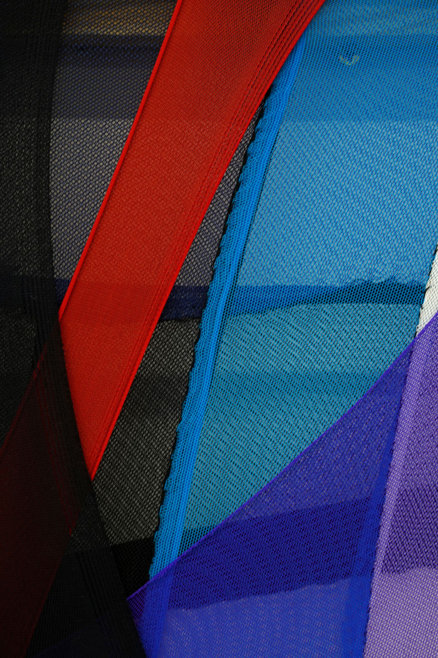 abstract fabric piece with blue, purple, green red and black