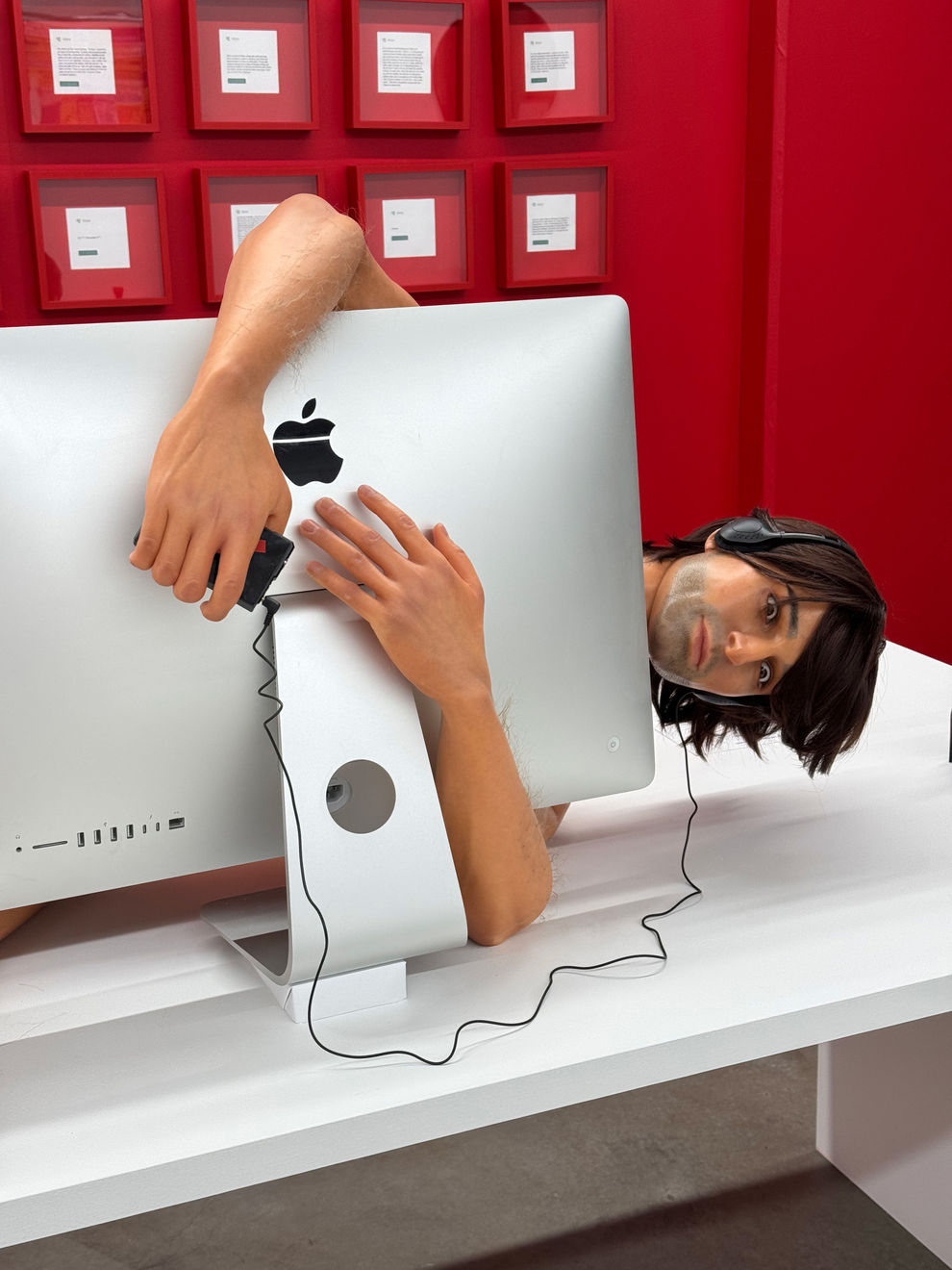 man on a desk hugging his computer