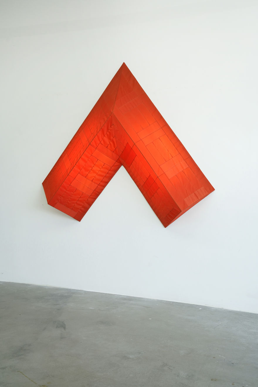 red arrow wall lamp mounted on a white wall