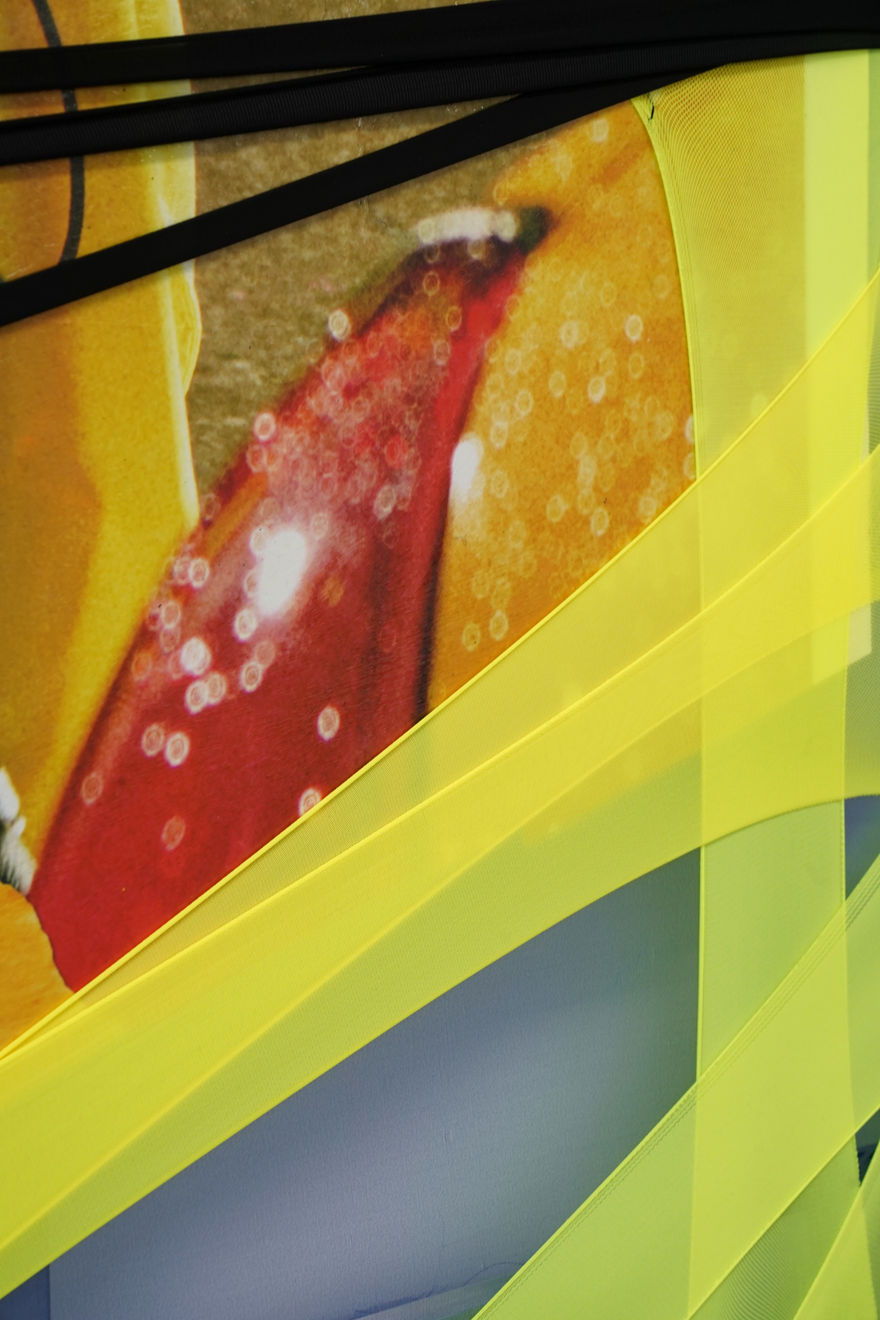 abstract fabric collage with a snippet of a photo of a person wearing a rain jacket