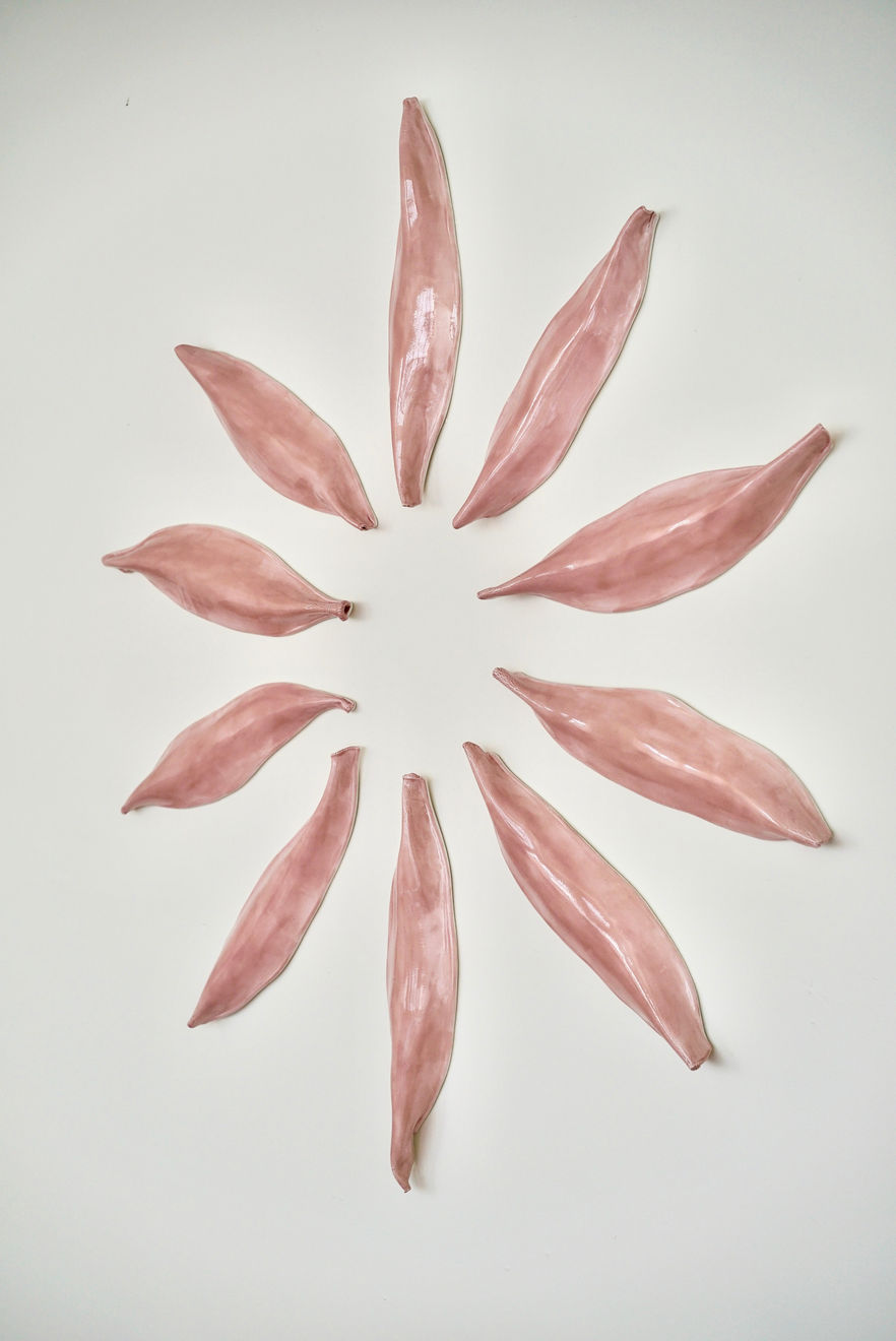 Pink Ceramic petals that can be arranged in multiple ways by slate gray gallery artist Angela Okajima-Kempinas