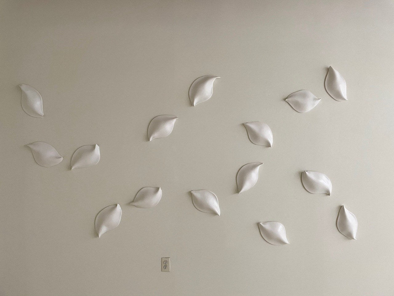 Ceramic petals that can be arranged in multiple ways by slate gray gallery artist Angela Okajima-Kempinas