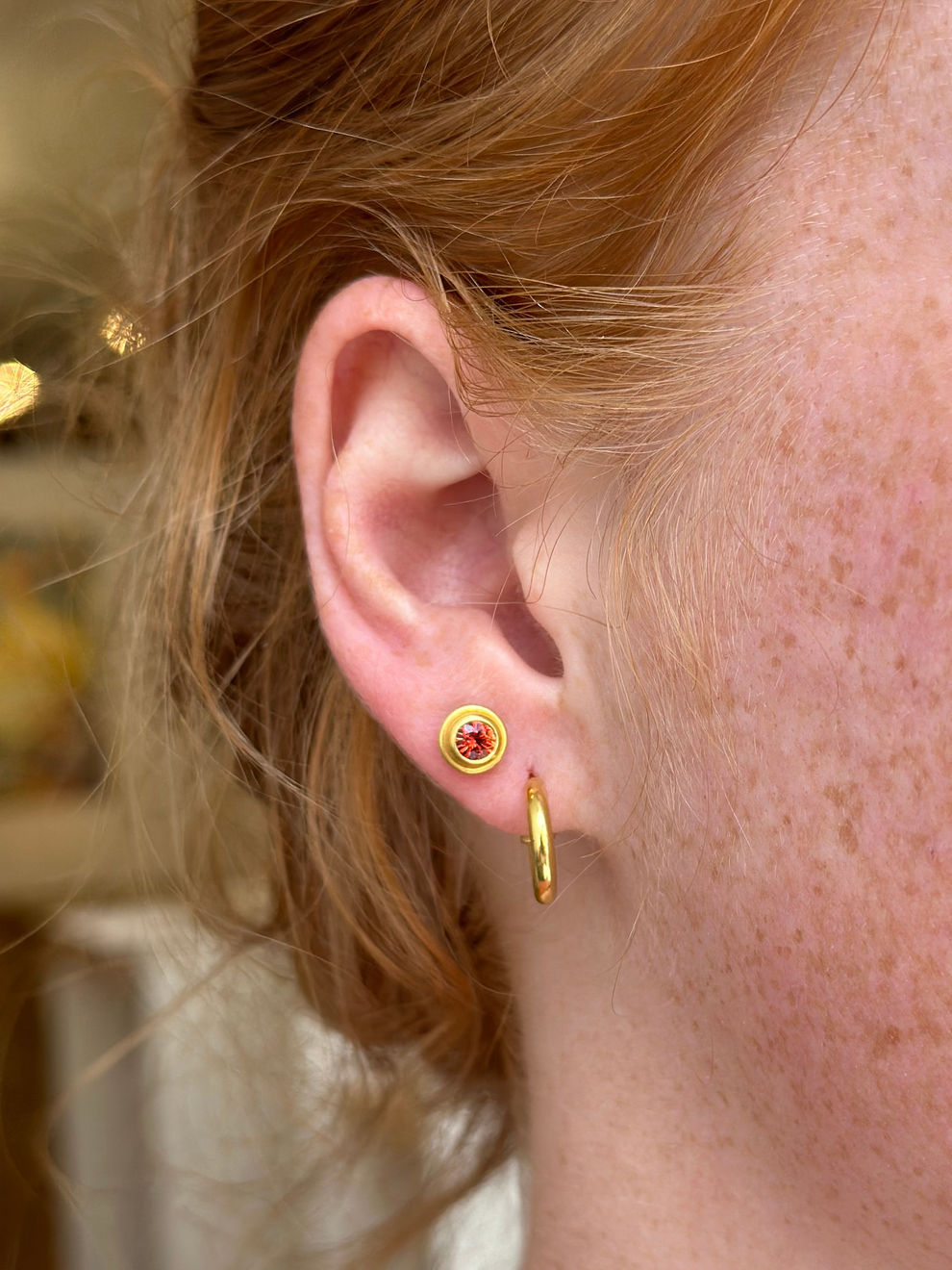 22k yellow gold and orange sapphire single stud earring by Fringe Gallery studio jeweler Nanci Modica