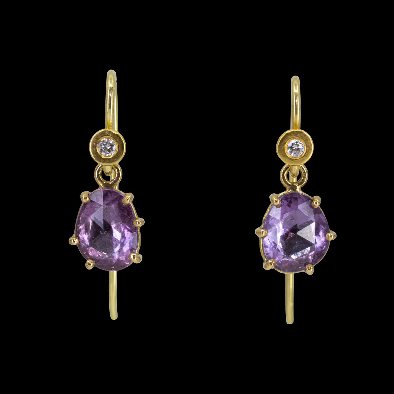 22k yellow gold earrings with prong set purple sapphires with platinum backings by Fringe Gallery studio jeweler Nanci Modica