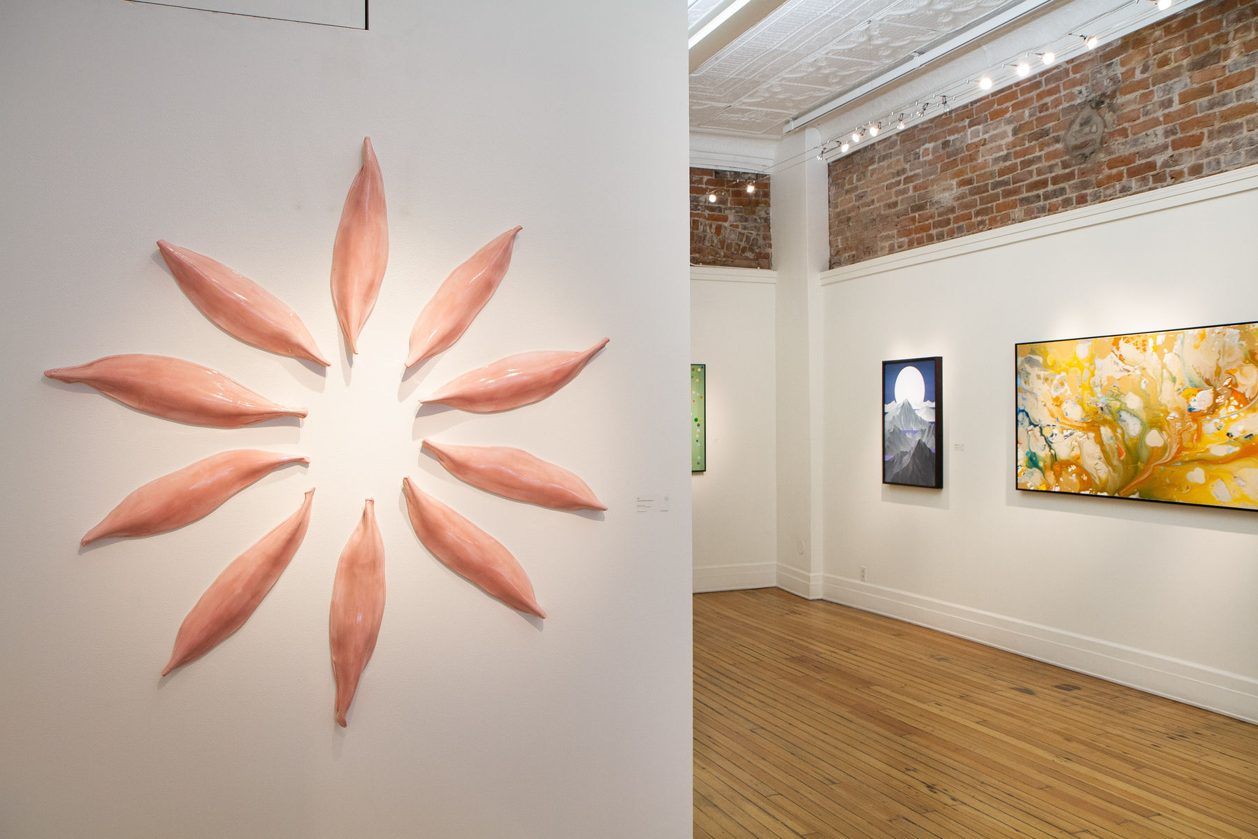 Pink Ceramic petals that can be arranged in multiple ways by slate gray gallery artist Angela Okajima-Kempinas