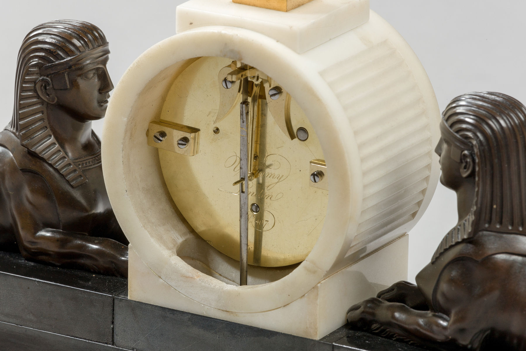 Patinated and Gilt Bronze Mounted Marble Mantel Timepiece