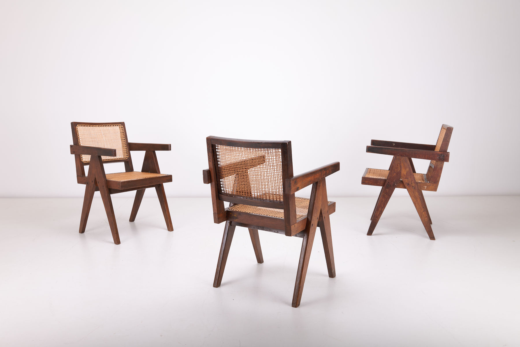 Set of spread out Pierre Jeanneret Conference Armchair with diagonal V-legs, crafted in teak and cane