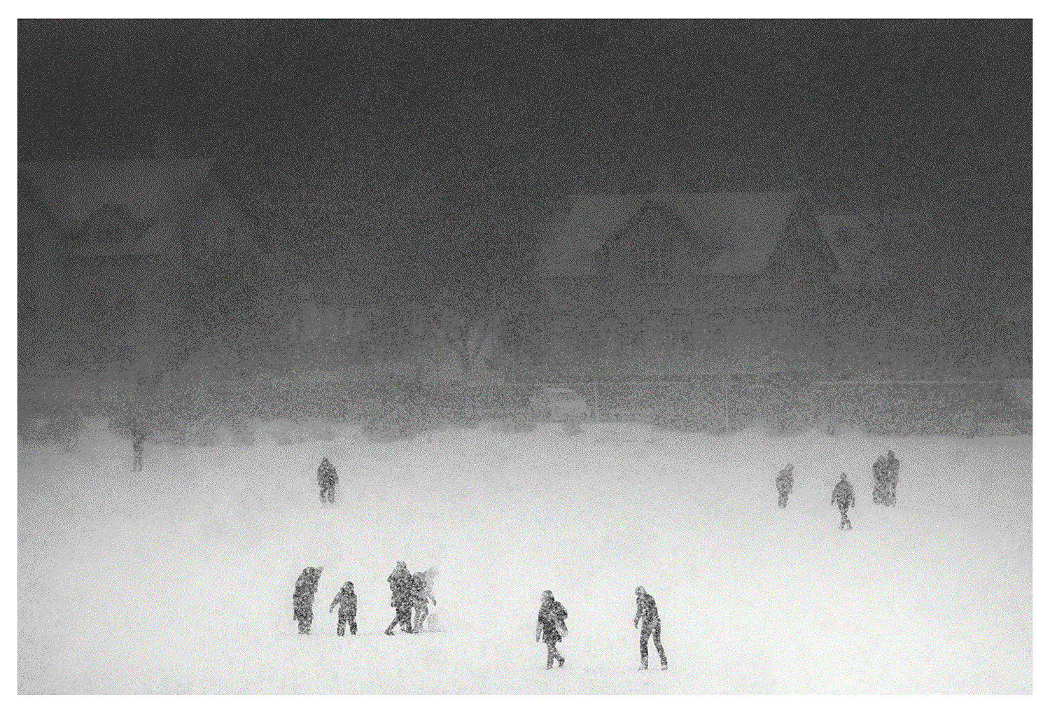 Black and white photograph of people playing on frozen pond in Reykjavik, Iceland during christmas.