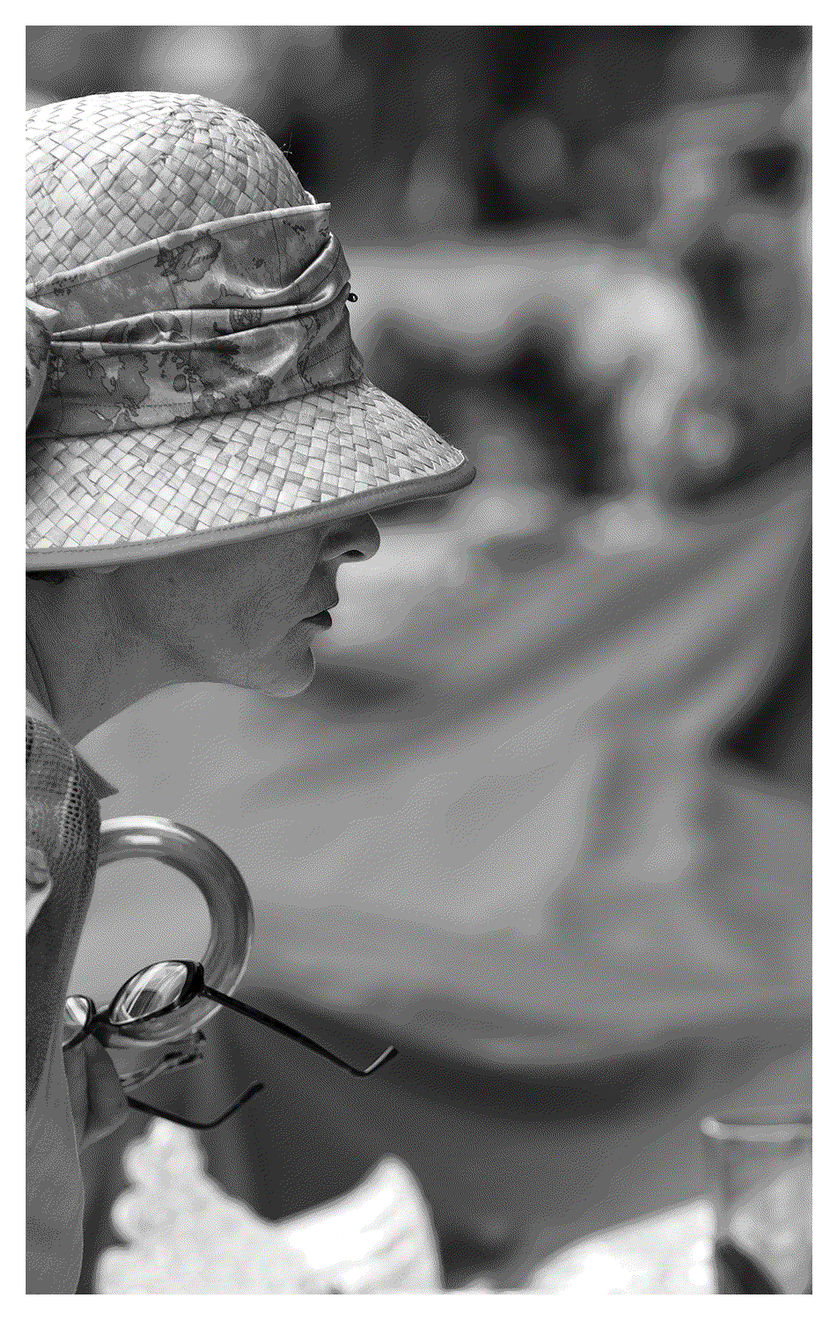 Black and white photograph of a woman at a flea market in Italy.