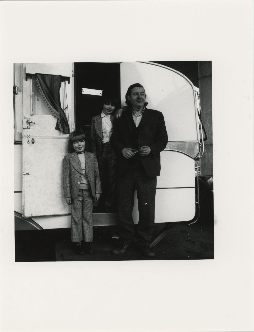 Jo Spence, Gypsies (Man with two children outside caravan), 1974