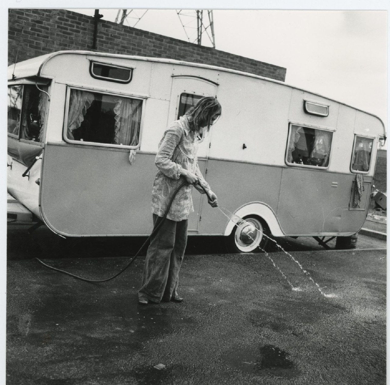 Jo Spence, Gypsies (Outside caravan, woman cleaning), 1974