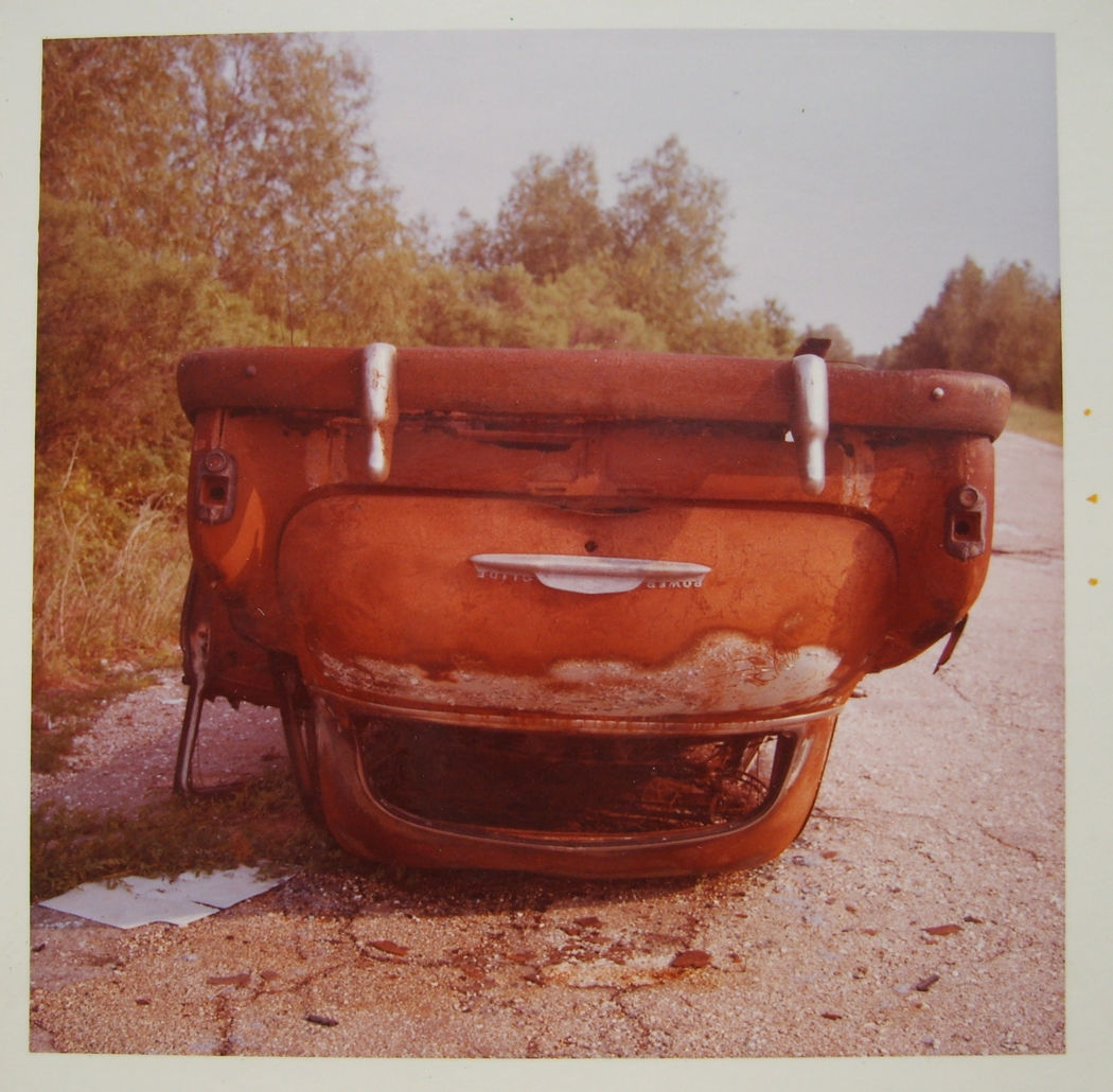 William Eggleston, Untitled (Red Rusted Upside-down Sedan), 1972