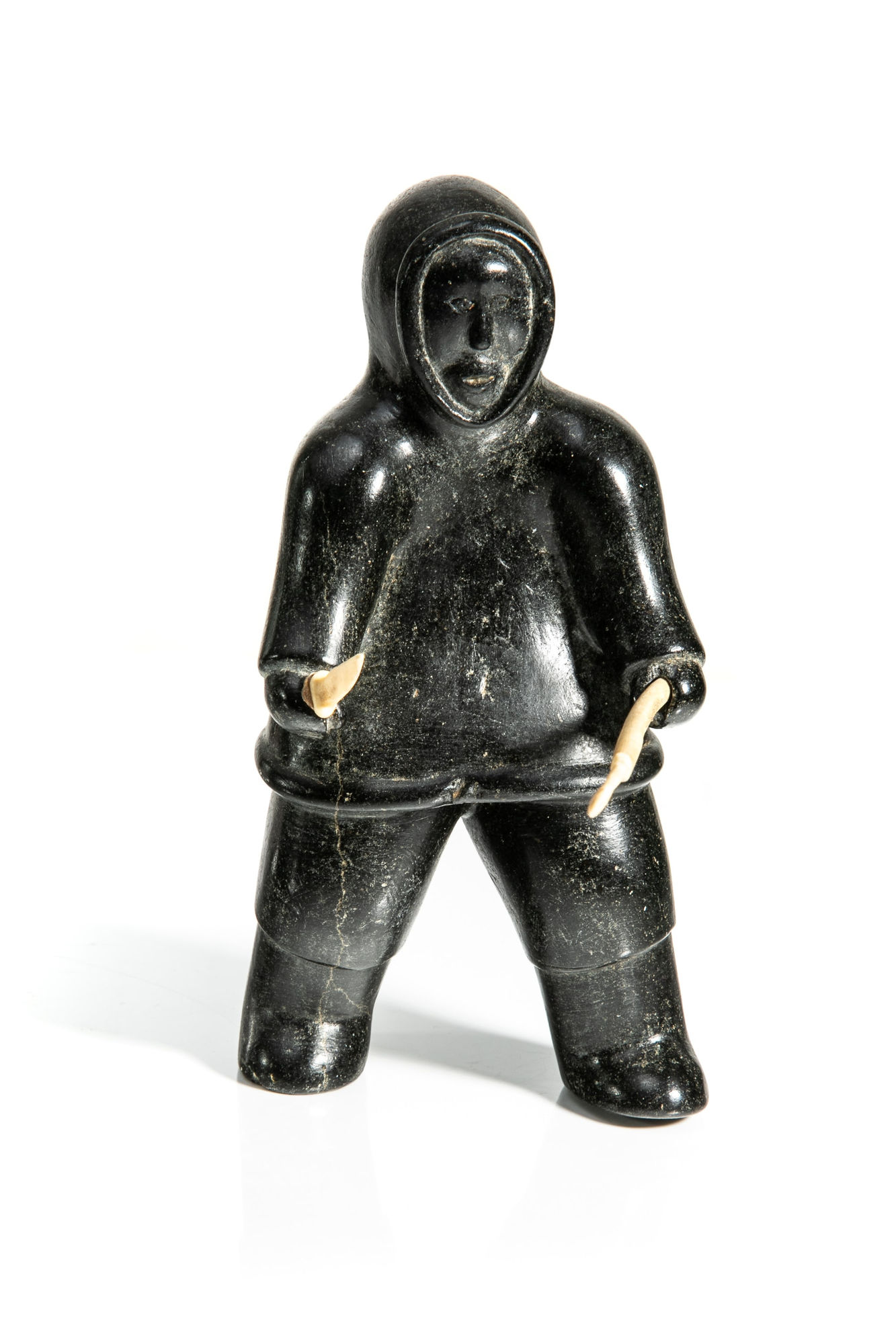 UNIDENTIFIED ARTIST, NUNAVIK (ARCTIC QUEBEC) Standing Man with Harpoon and Knife, late 1950s stone, ivory, and hide, 6.5 x 2.25 x 2.5 in (16.5 x 5.7 x 6.3 cm) $450