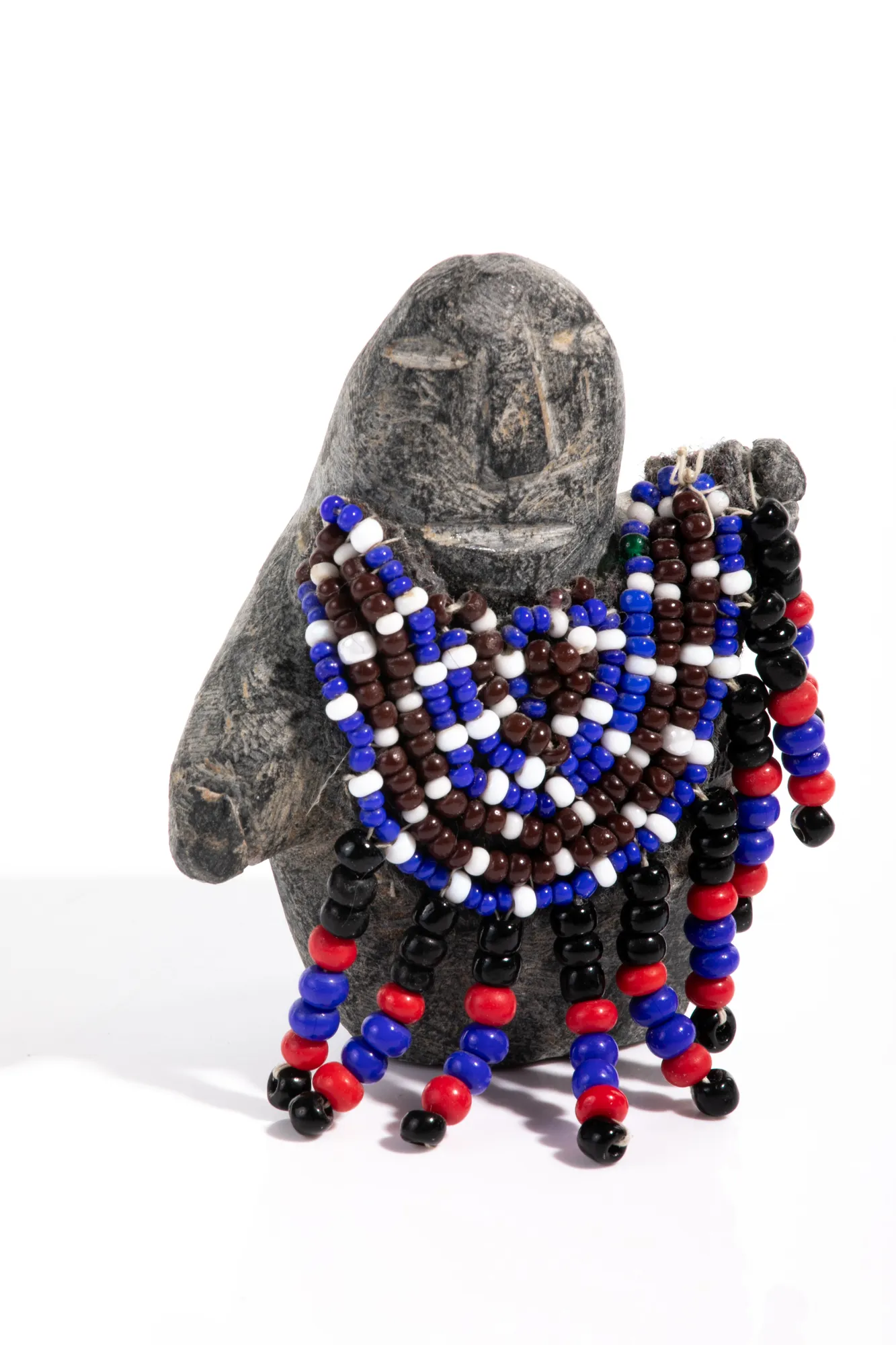 EVA TALOOKI ALIKTILUK (1927-1994) ARVIAT (ESKIMO POINT) Waving Woman in Beaded Amautiq, mid-late 1980s stone, cotton string, felt, and glass beads, 3 x 2.5 x 1.75 in (7.6 x 6.3 x 4.4 cm) $600