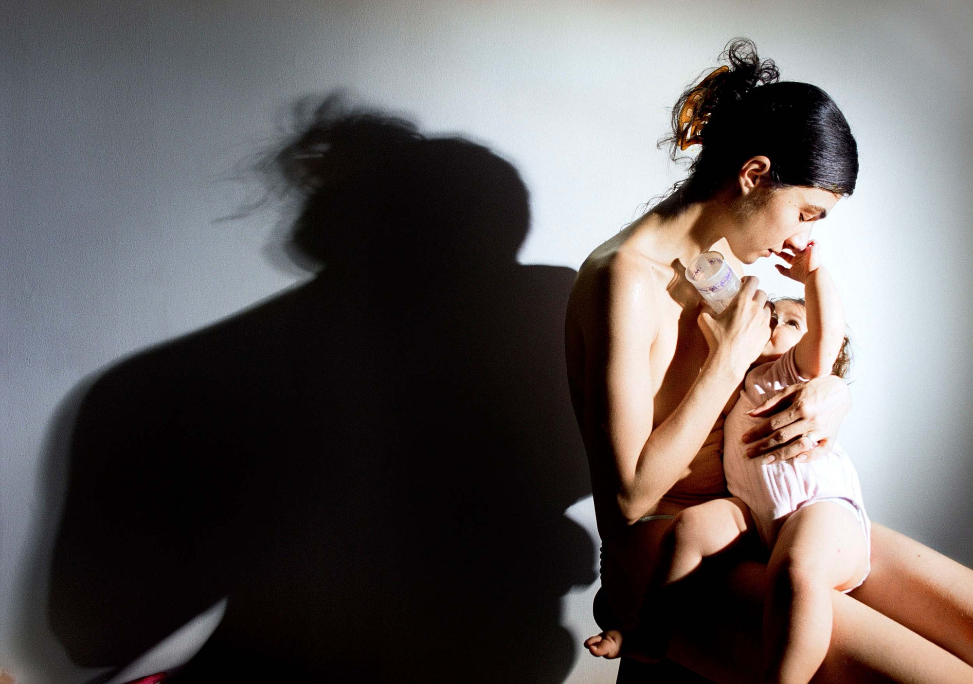 Elinor Carucci, Feeding Emmanuelle from a plastic bottle after I stopped breast-feeding, 2005