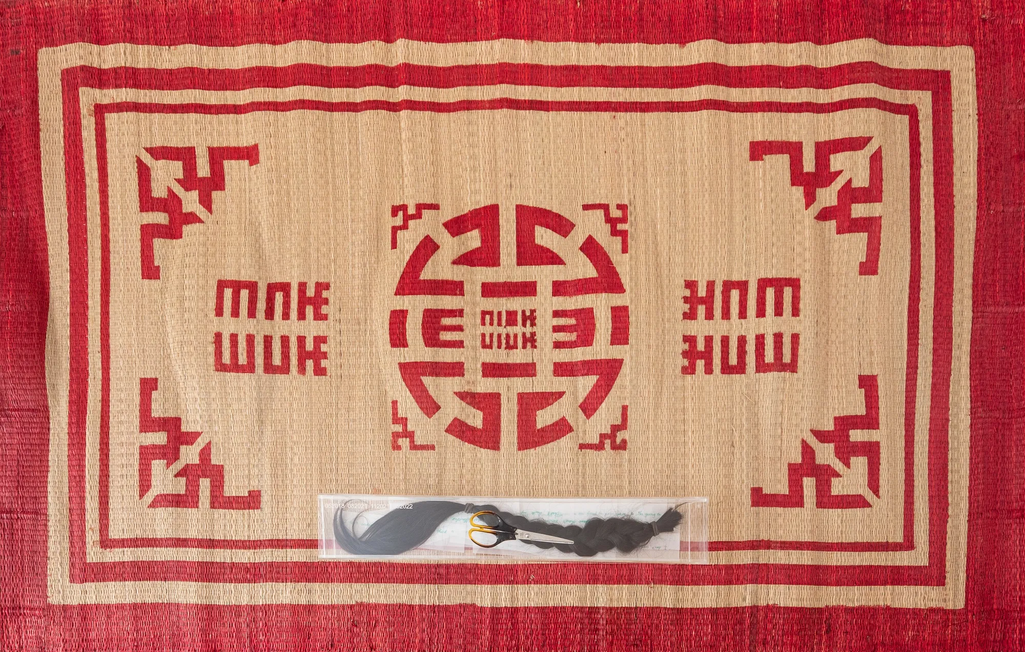 Quỳnh Lâm The Price of Humanity (Objects), 2022 Woven mat: 120 x 188 cm, acrylic box with etching "052018", "112021", "052022": 64 x 11 x 8.5 cm, artist's own scissors, hair, handwritten notes on paper matt: 120 x 188 cm box: 64 x 11 x 8.5 cm